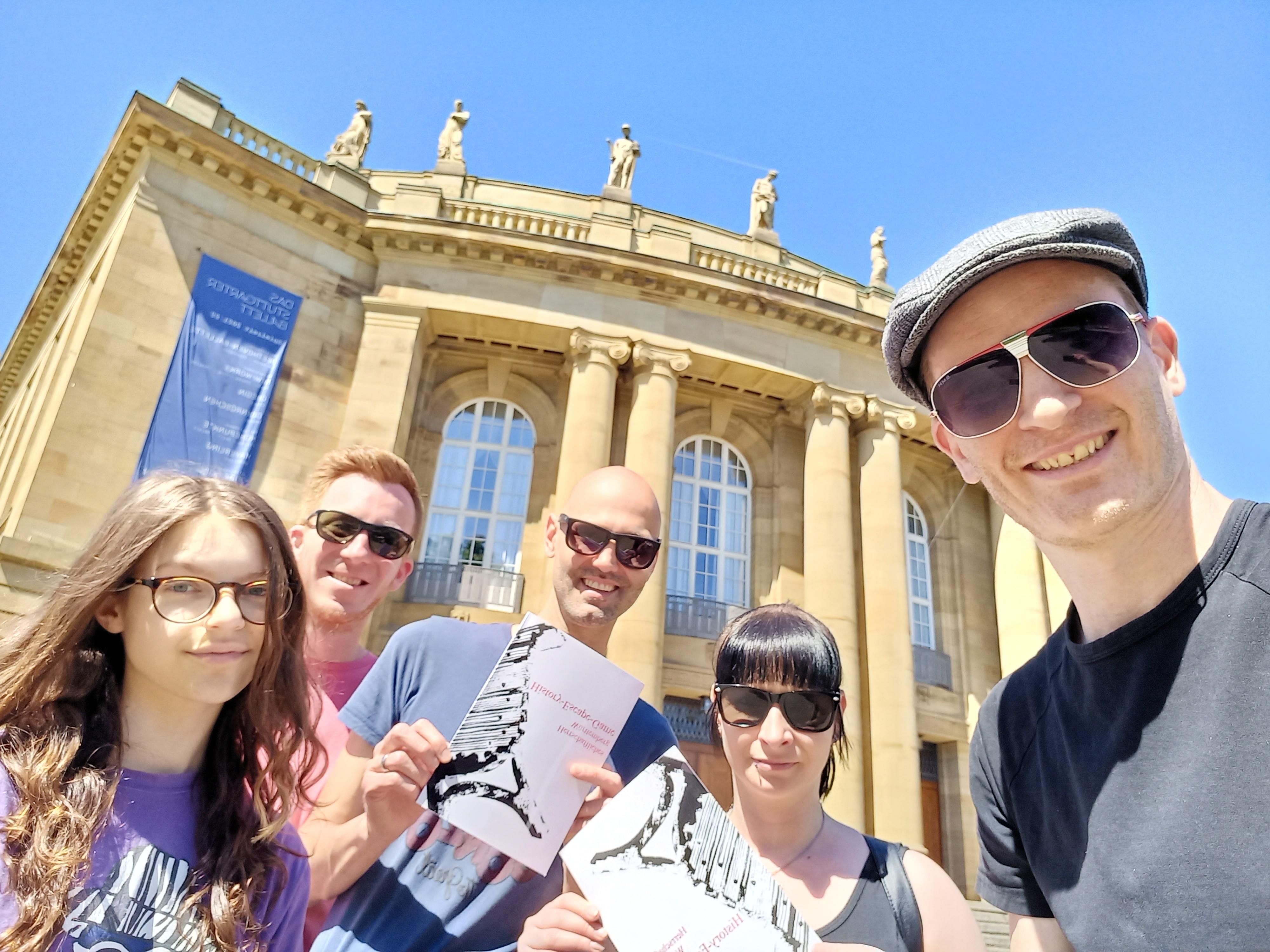 Eine Gruppe beim Outdoor Escape Game vor einem historischen Gebäude in Stuttgart.