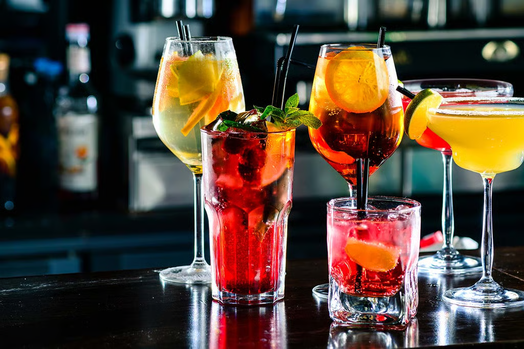 Various colorful cocktails on a bar counter.
