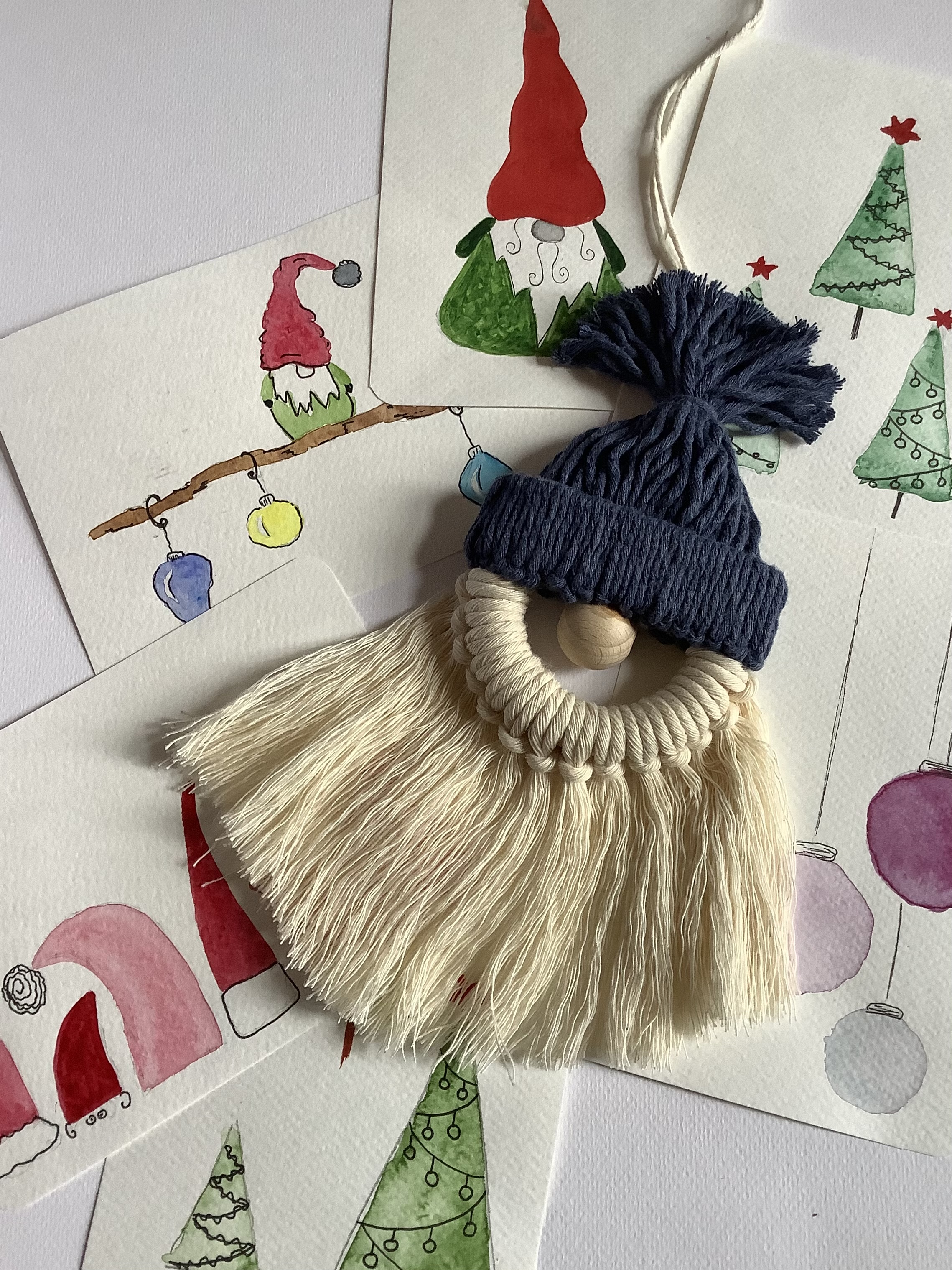 Handmade gnome ornament on Christmas-themed cards.
