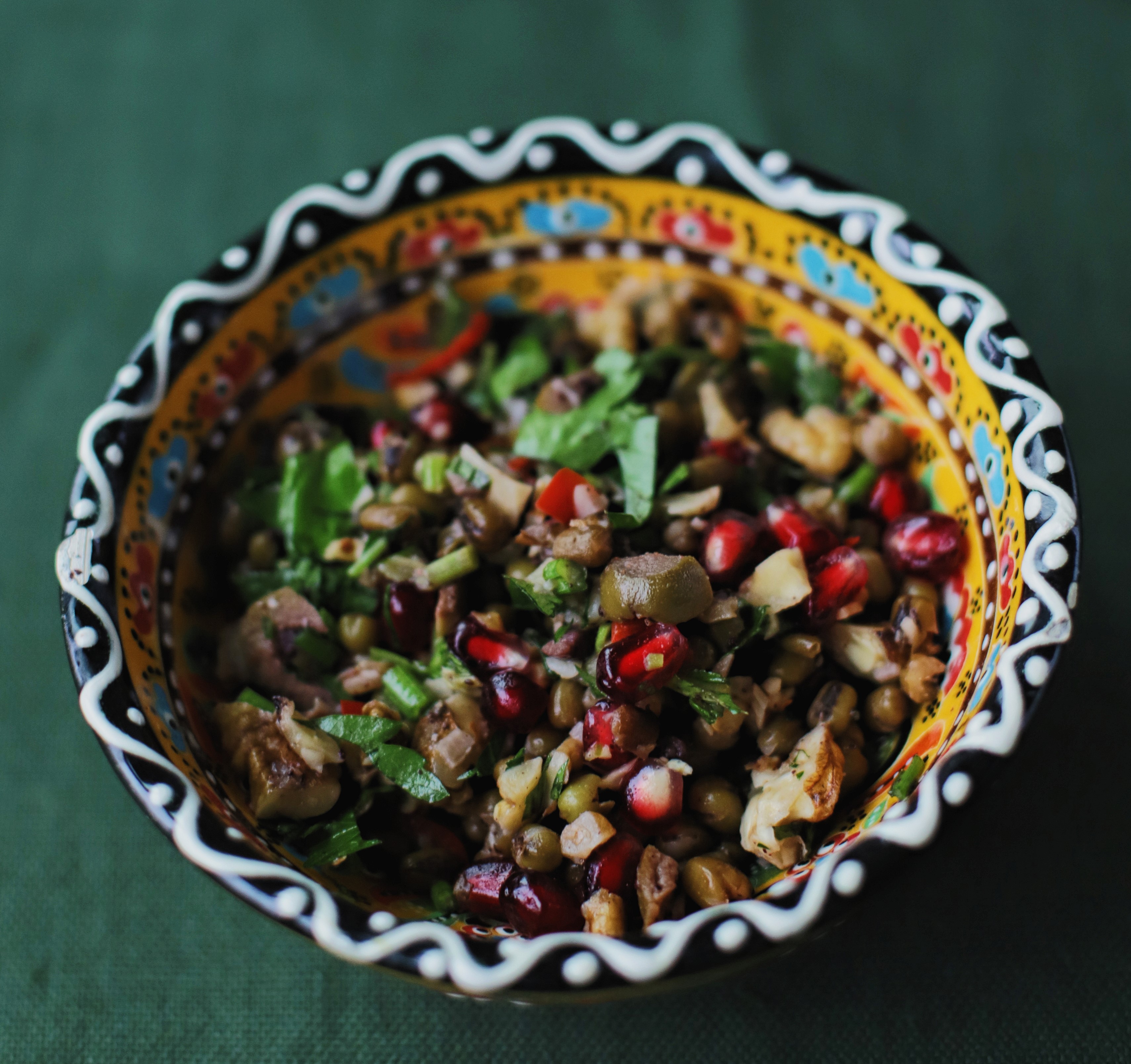 Colorful salad with pomegranate in decorative bowl.