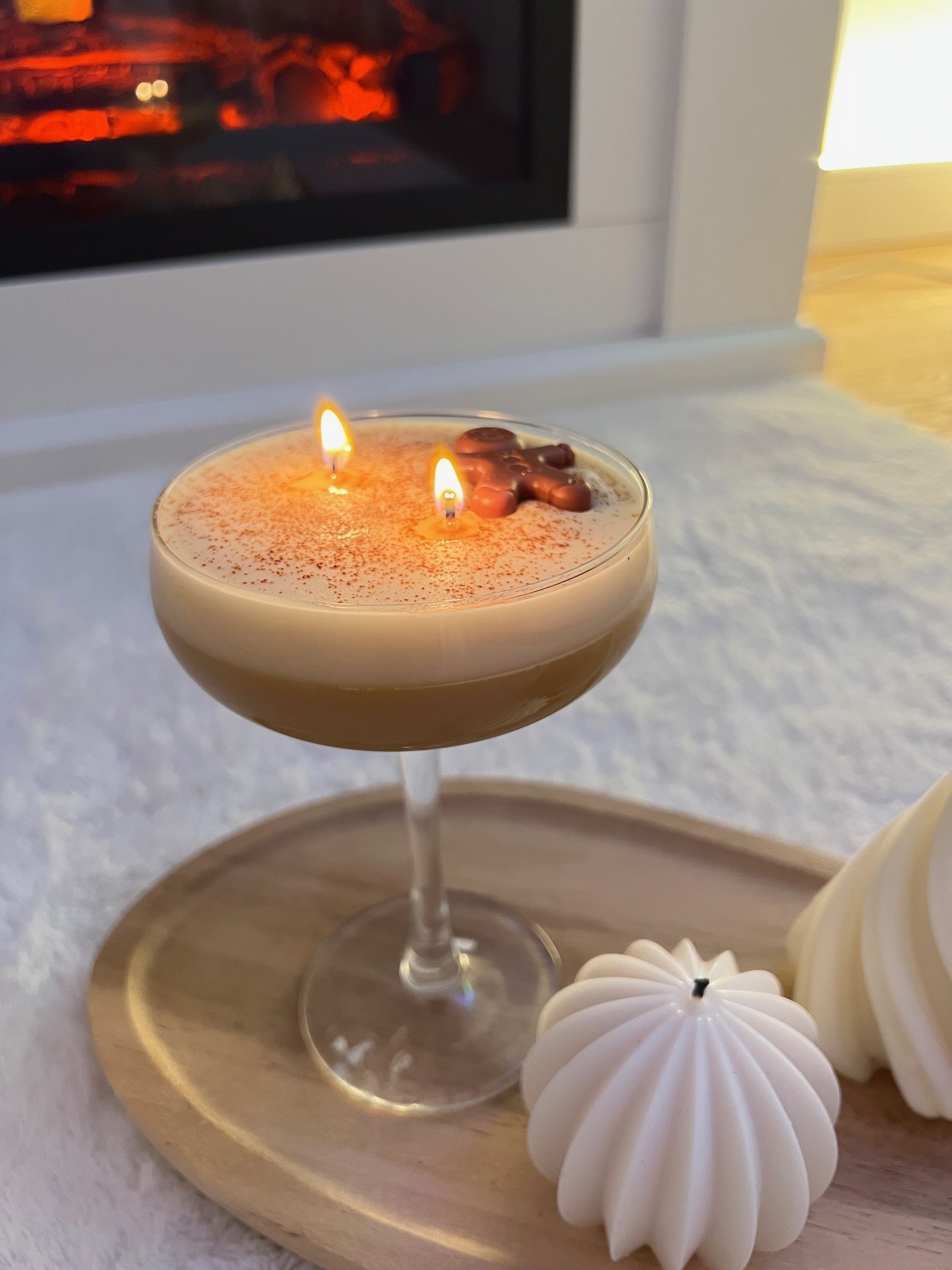 Cocktail mit brennenden Kerzen im Glas.