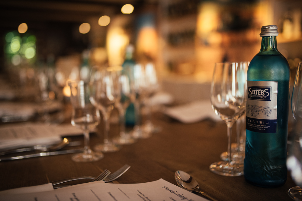 Blaue Flasche auf elegant gedecktem Tisch.