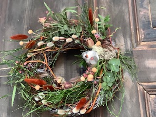 Floral wreath with small bird on door.