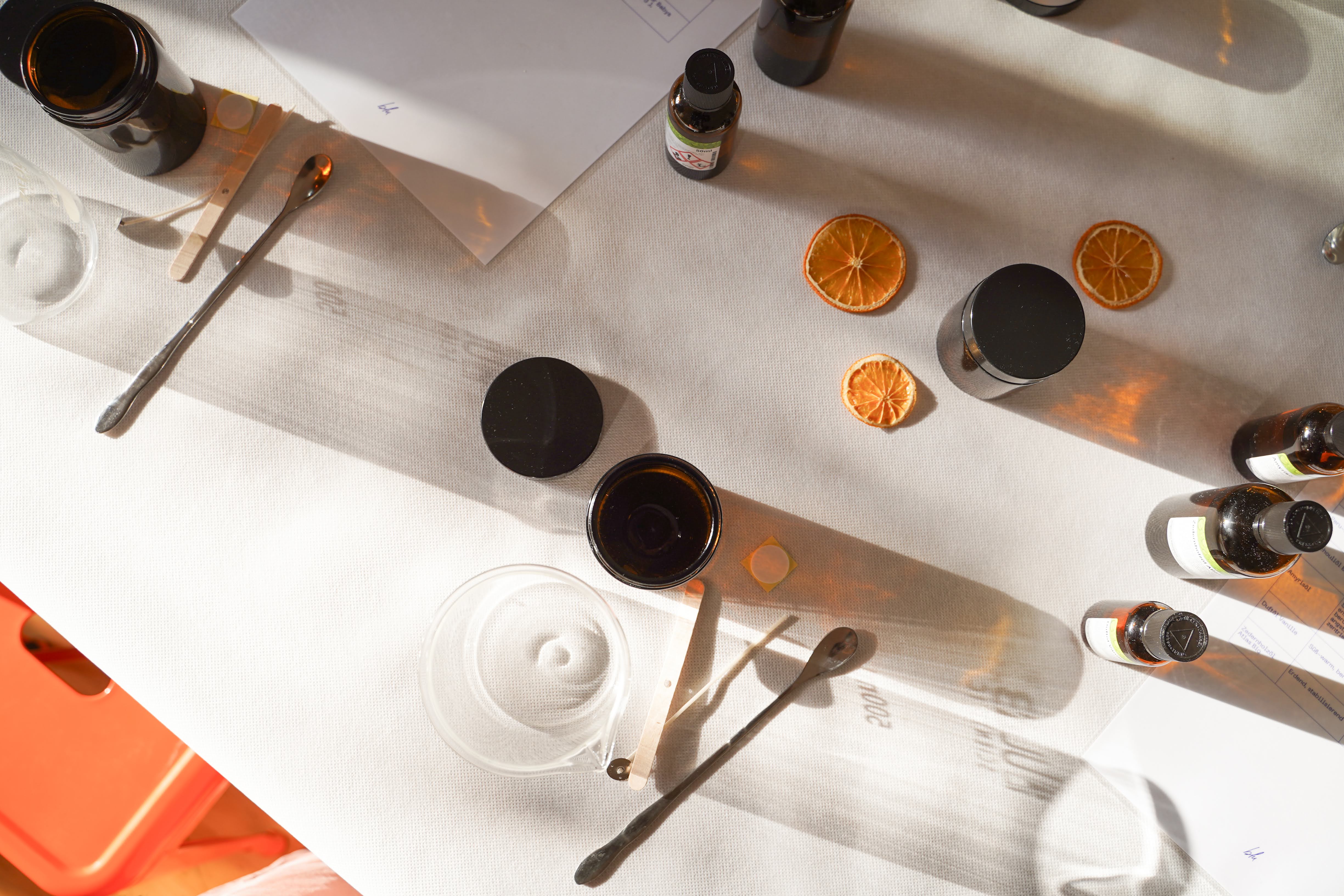 Essential oils and dried oranges on table.