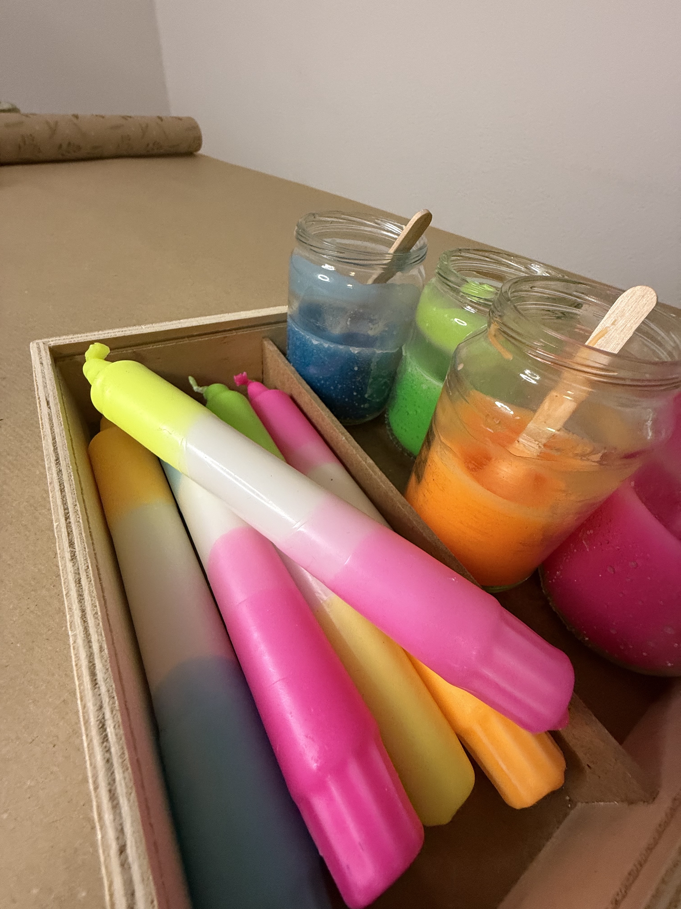 Colorful candles and jars with colored wax.