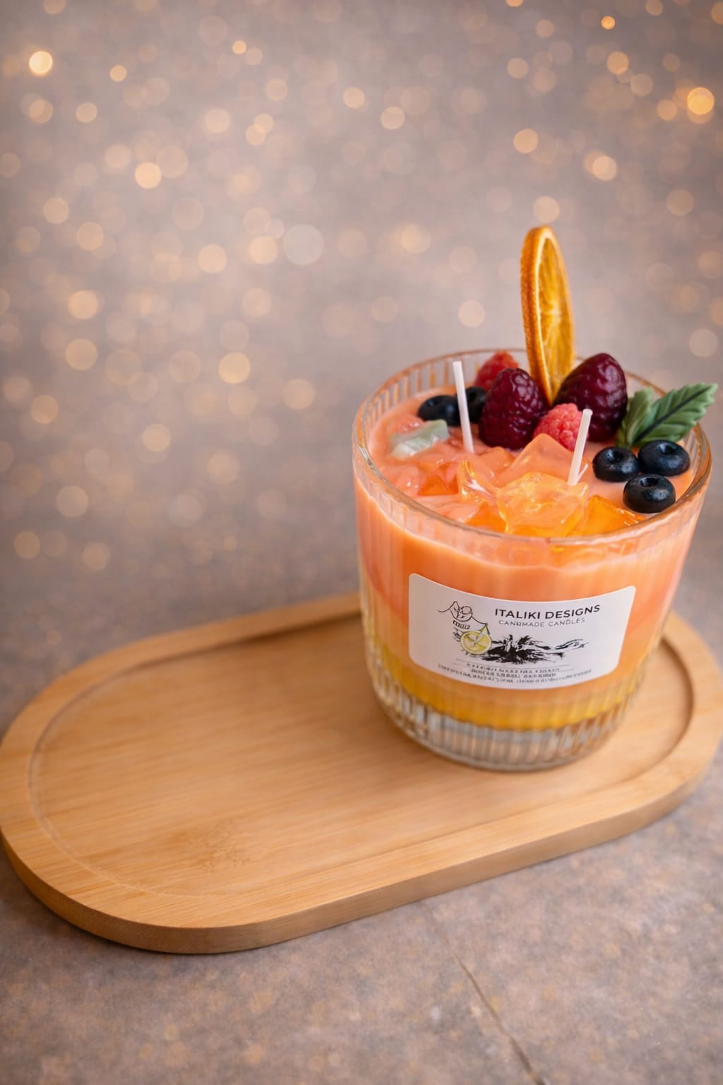 Candle resembling fruit cocktail on table.