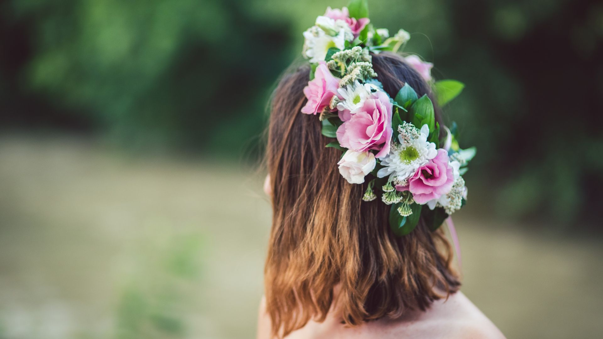 Woman with floral crown in nature.