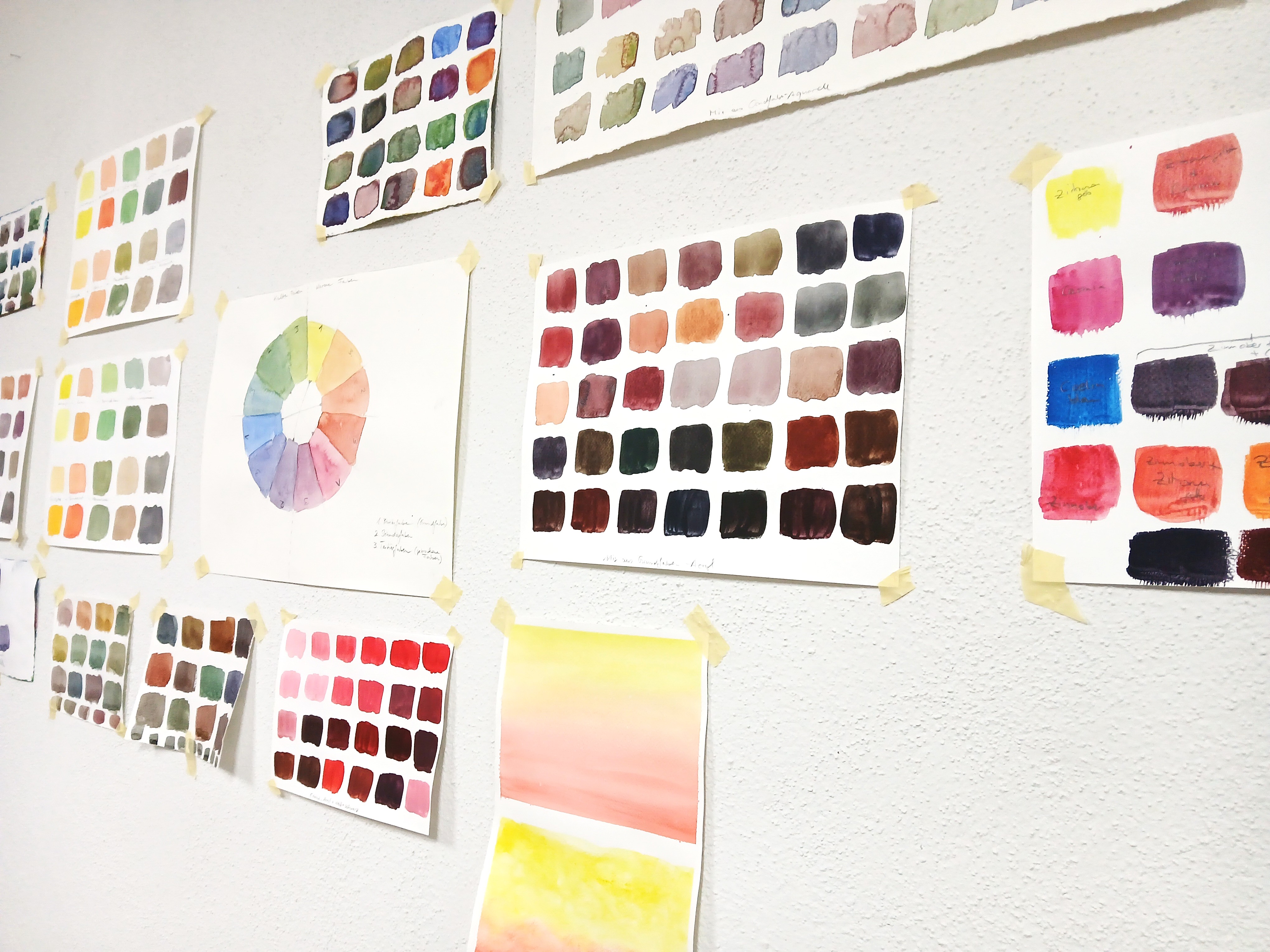 Paint swatches and color wheel on wall.