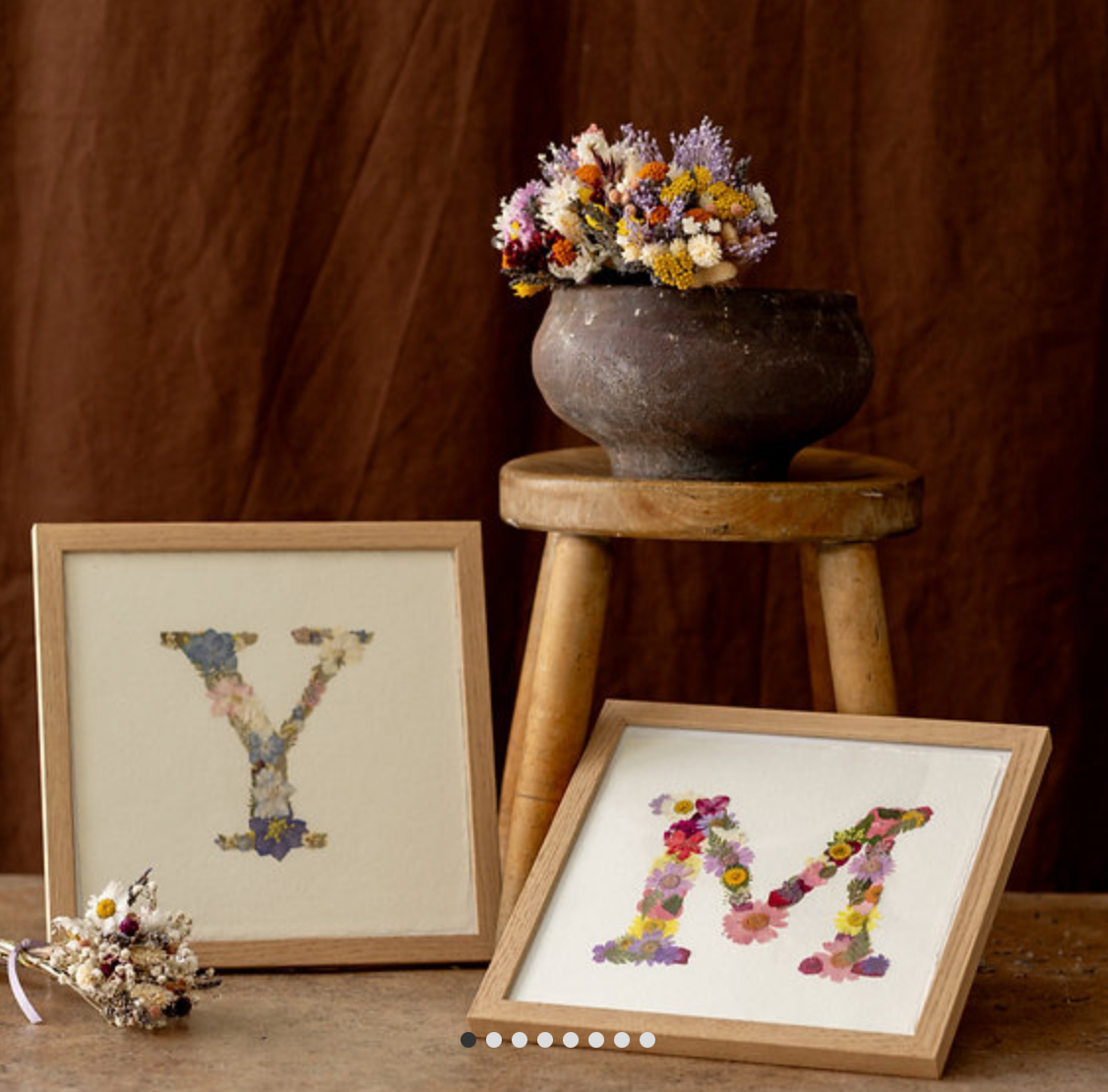 Floral letters Y and M in frames.