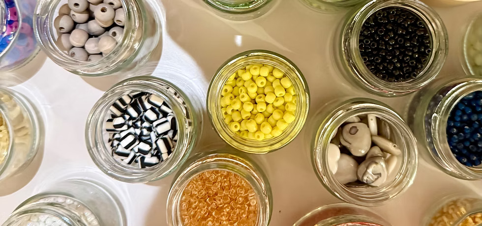 Glass jars filled with colorful beads.