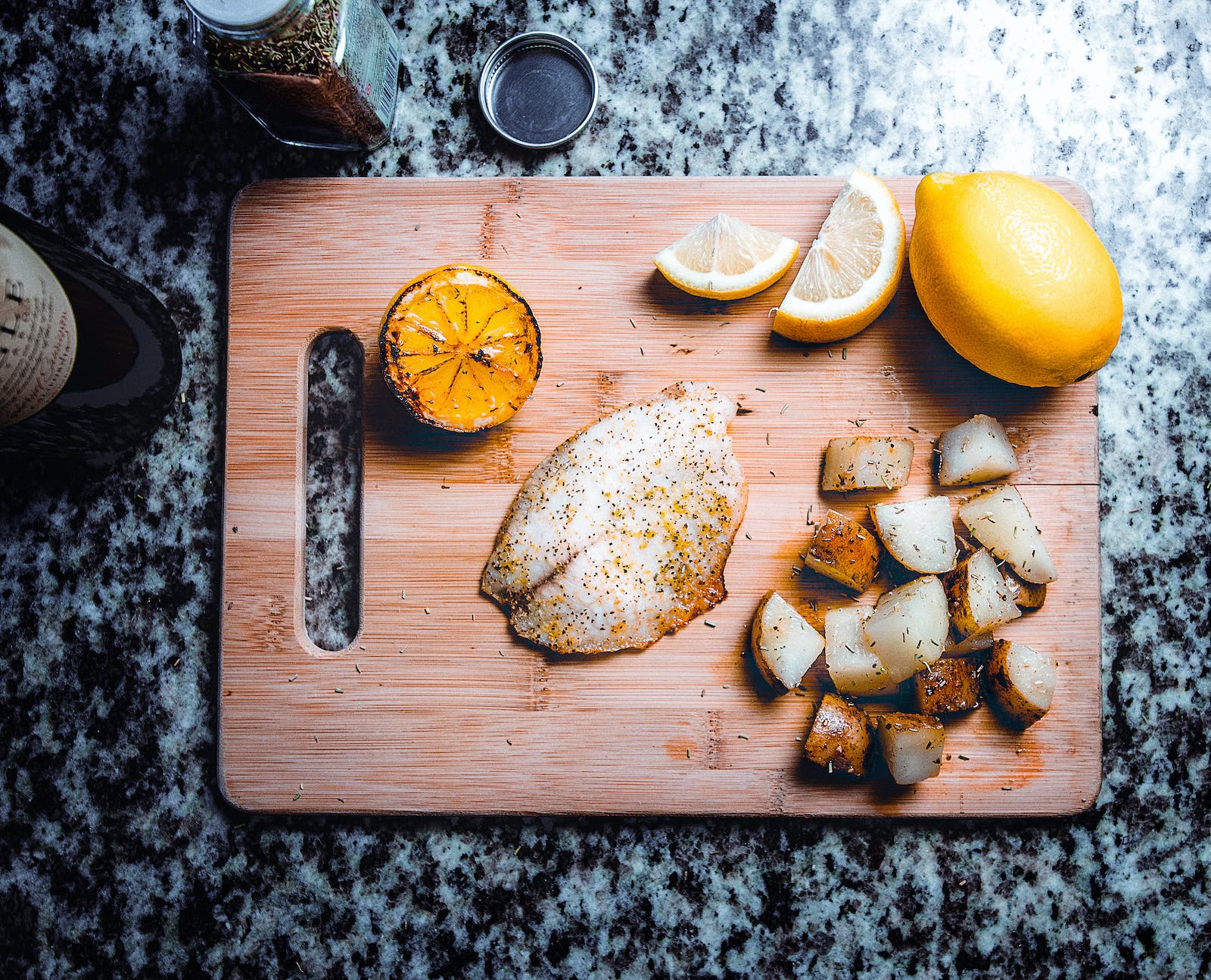 Prepare fish fillet and vegetables on a cutting board.