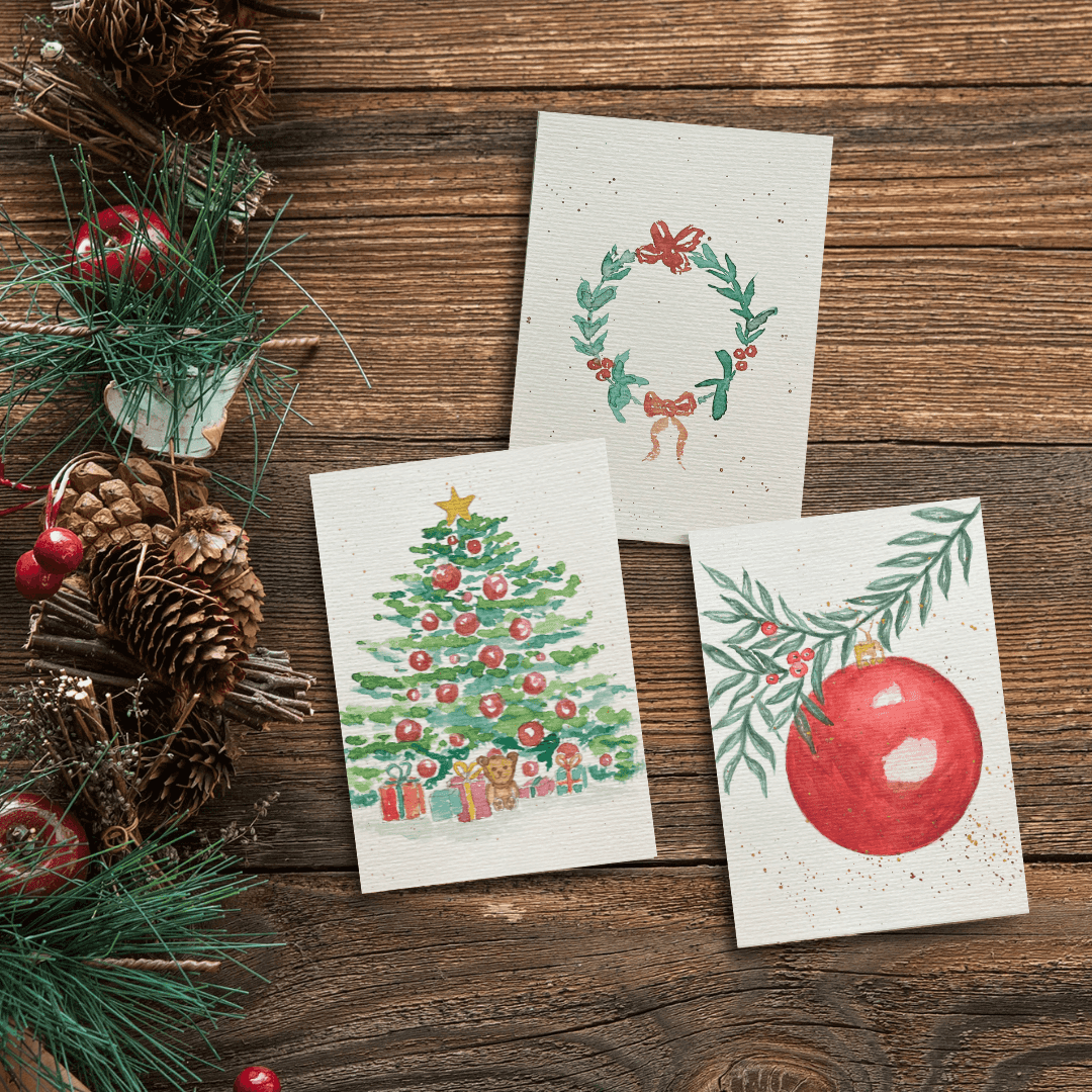 Christmas cards with festive designs on wood.
