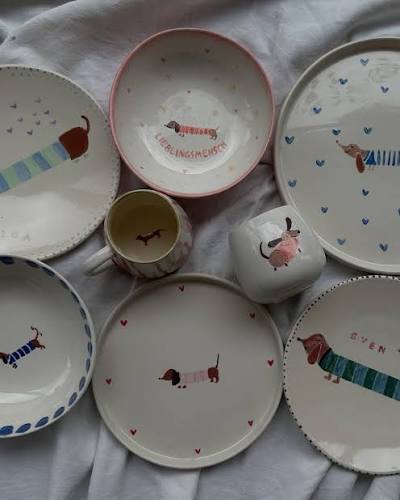 Ceramic plates and cups with dachshund designs.