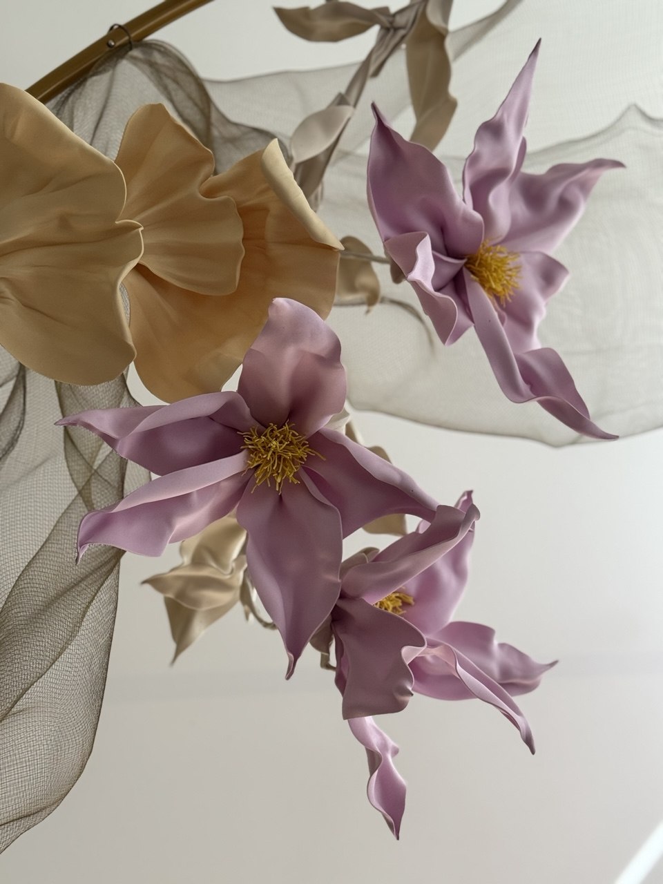 Pink and beige flowers against soft fabric.