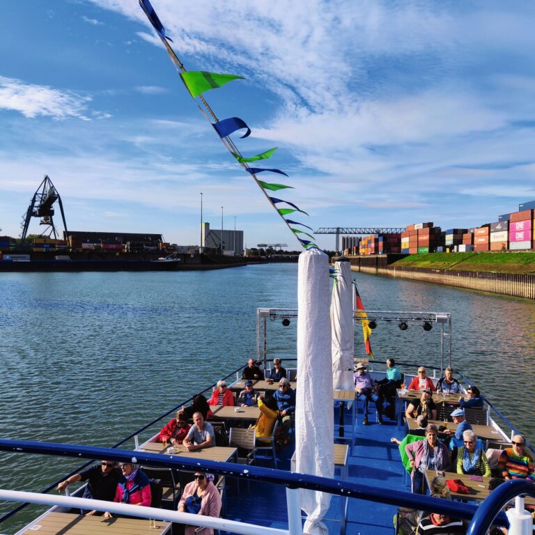 Boat passengers enjoying a sunny river cruise.