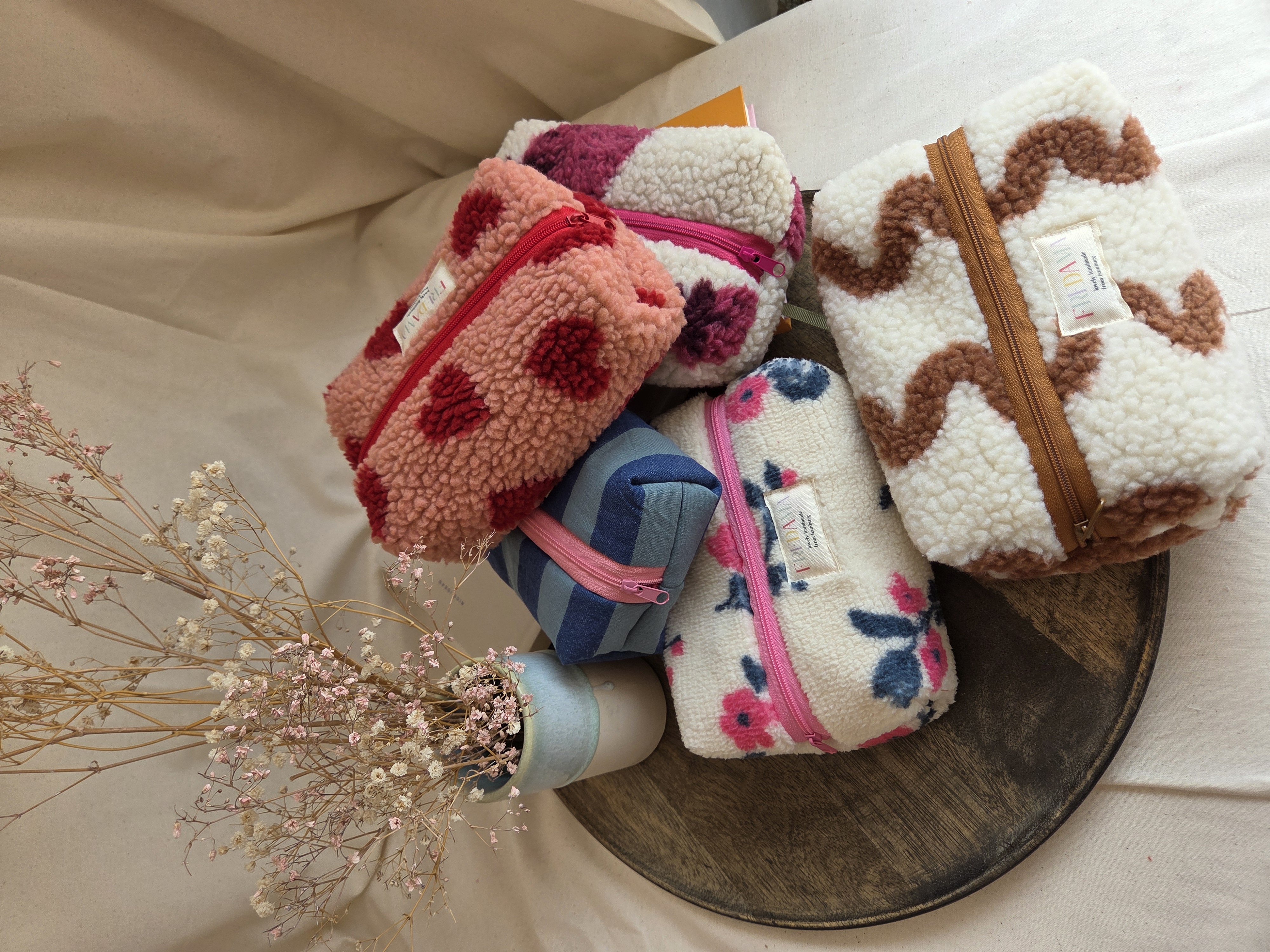 Patterned pouches arranged on a wooden tray.