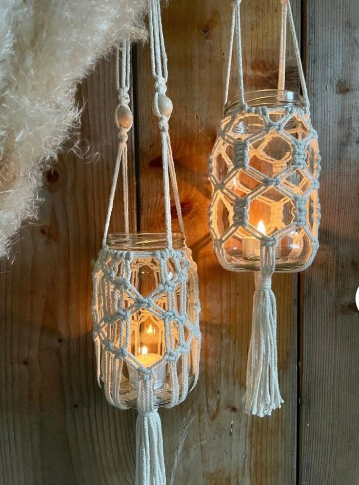 Hanging glass jars with macramé rope covers.