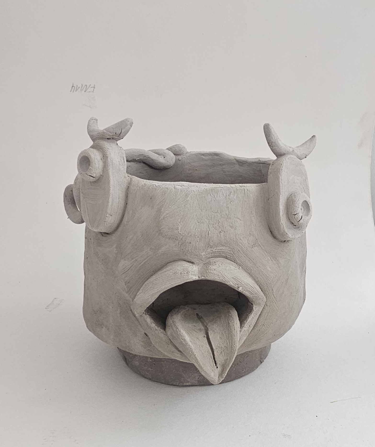 Clay pot shaped like a bird's head.