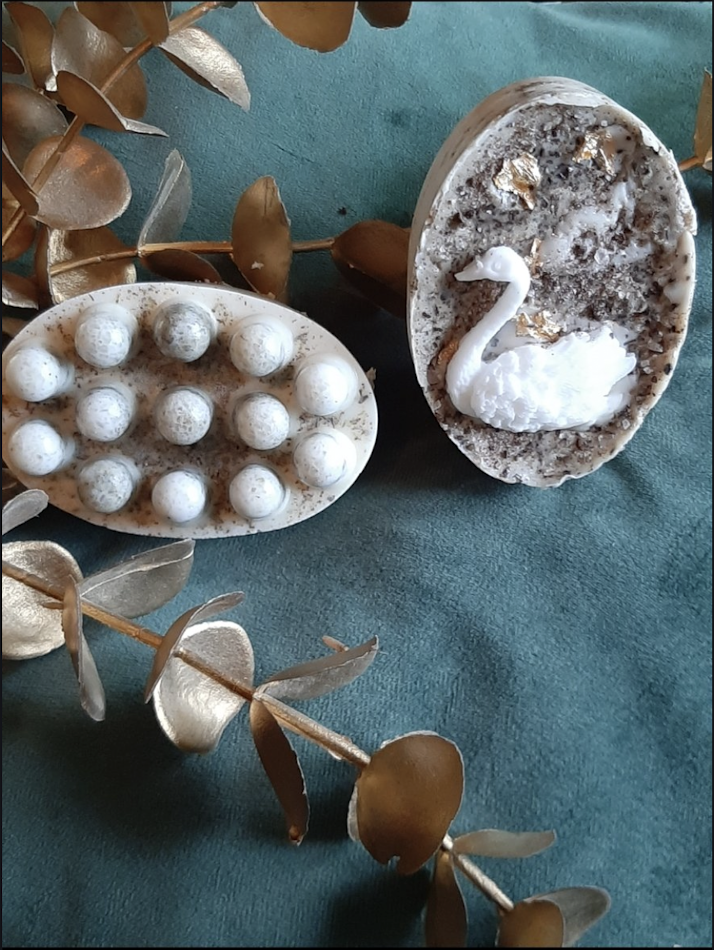 Decorative soaps with swan and sphere design.