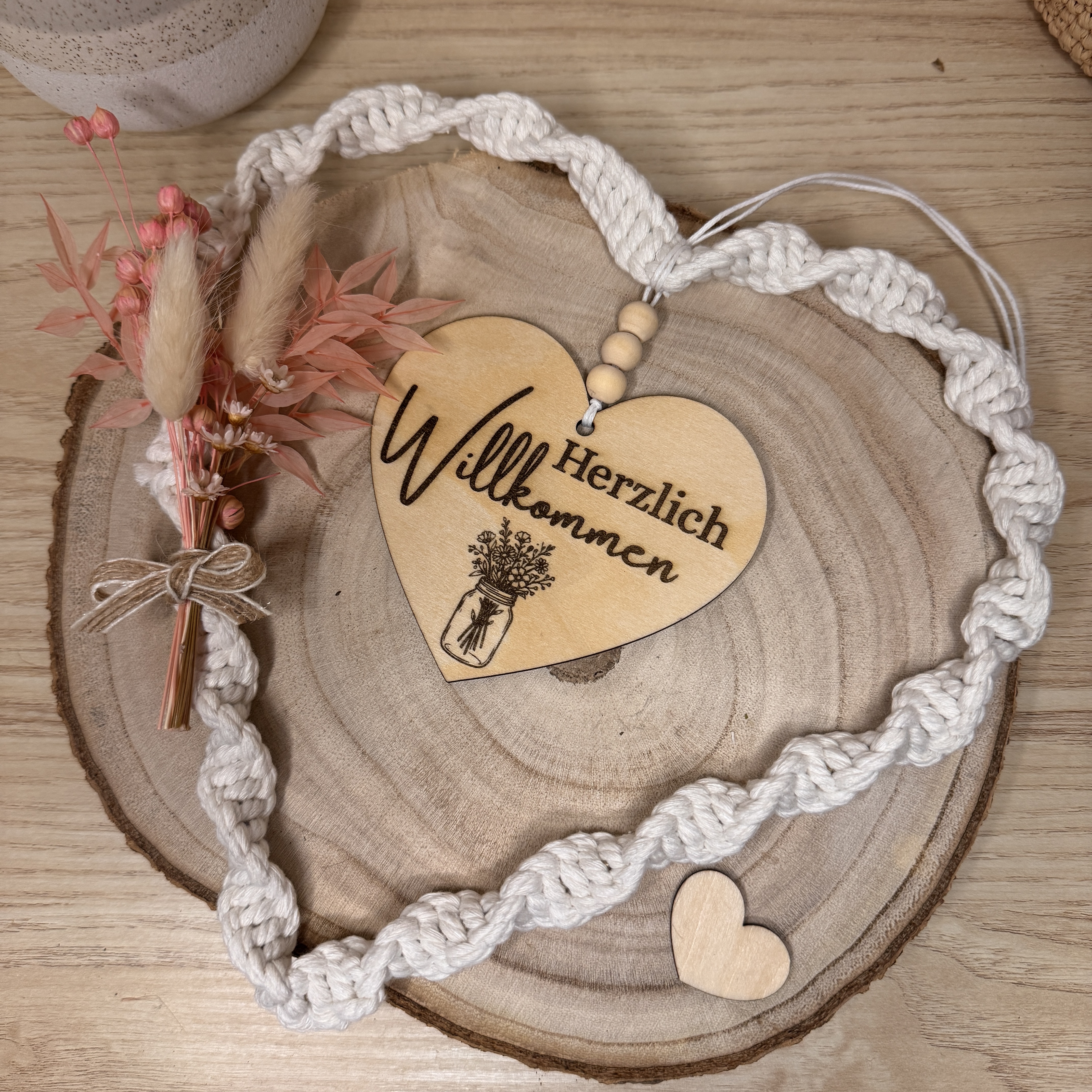 Wooden heart with 'Willkommen' on braided cord.