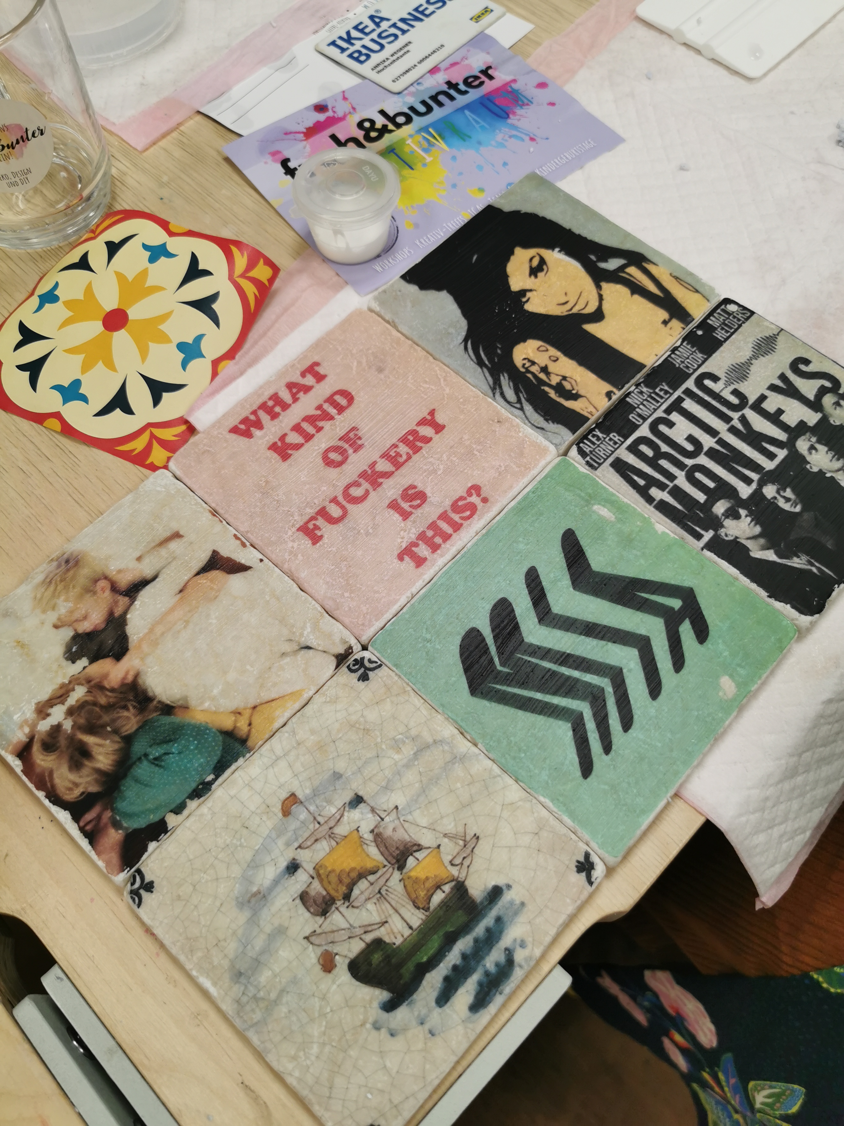 Decorative coasters with various designs on table.