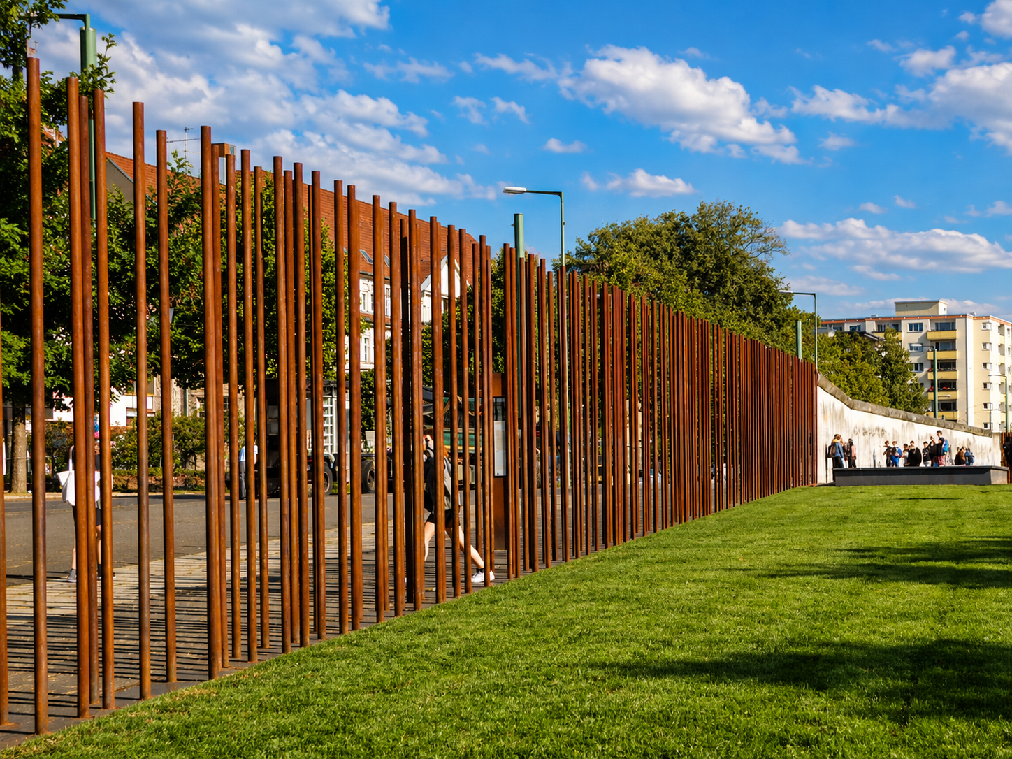 Metal poles creating a wall in a park.