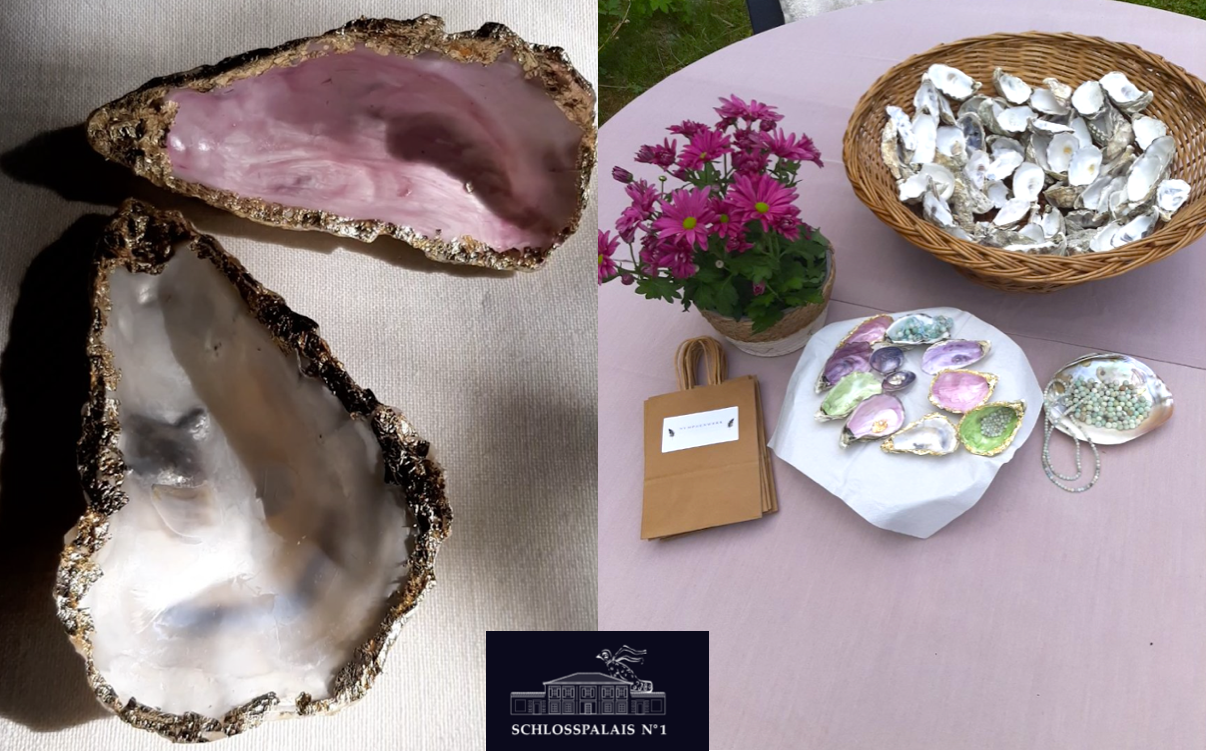 Decorative oyster shells on table with flowers.