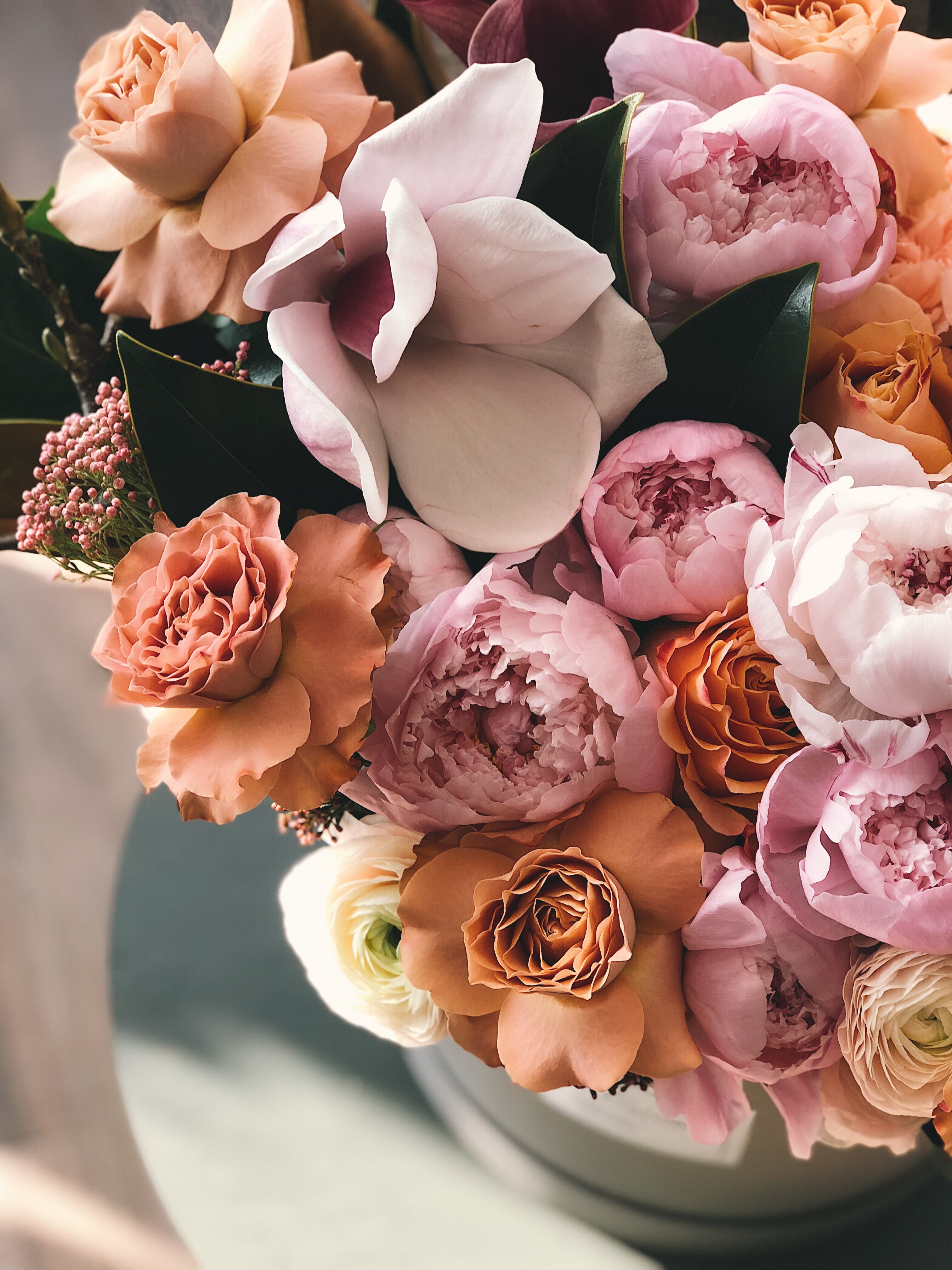 Different colored flowers are lush in an arrangement.