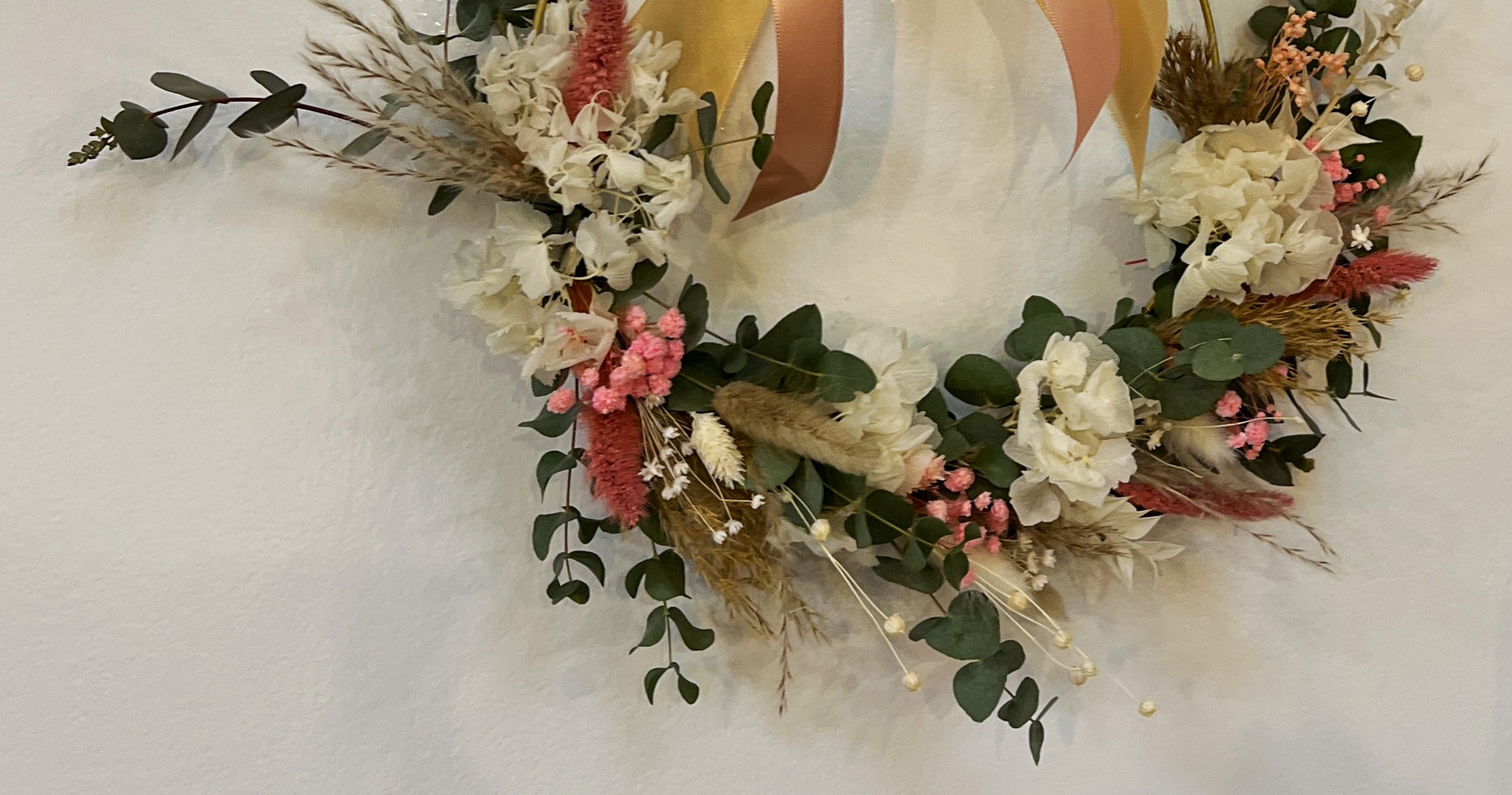 Floral wreath with pink and white flowers.