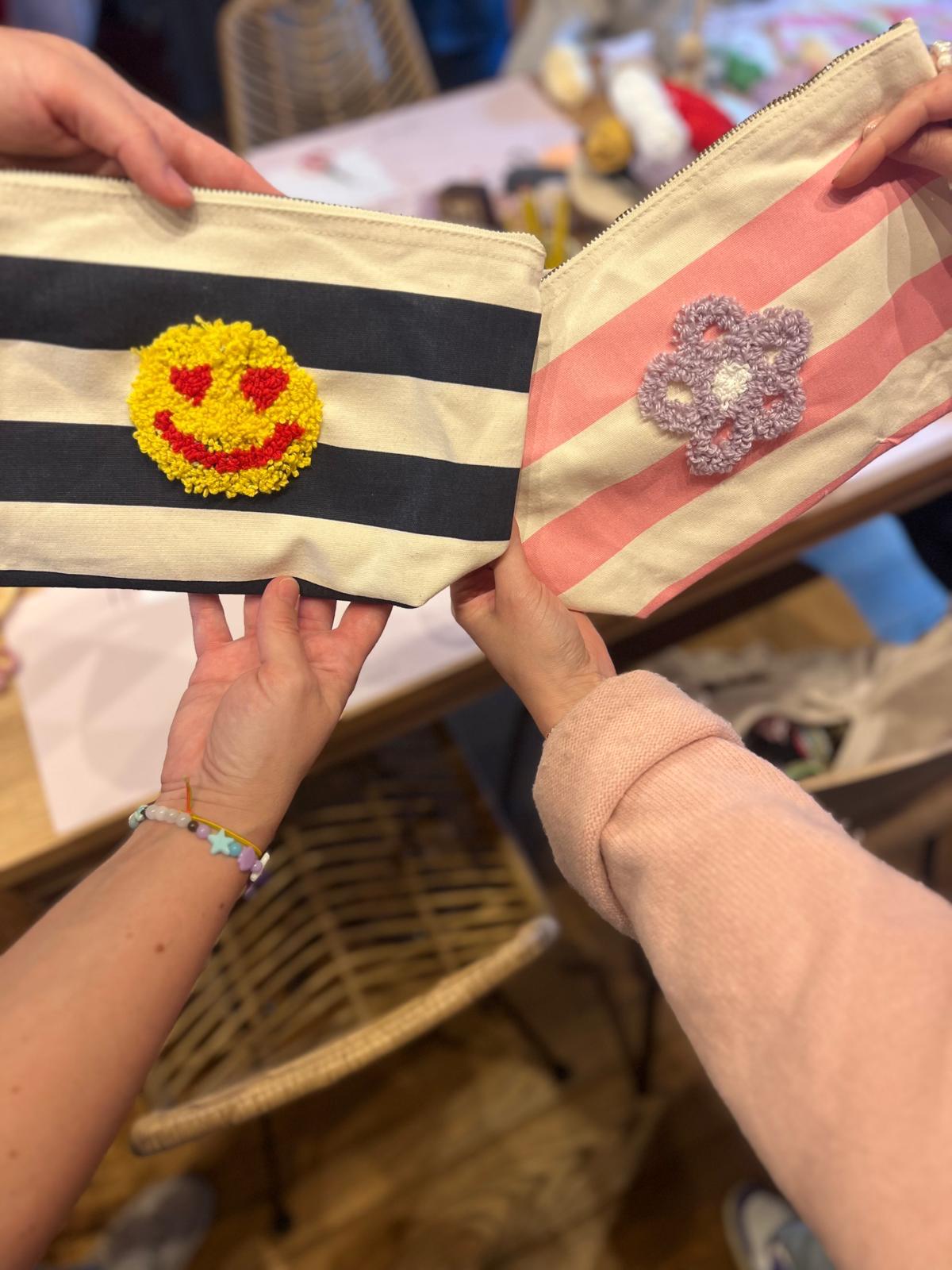 Two striped pouches with crochet designs.