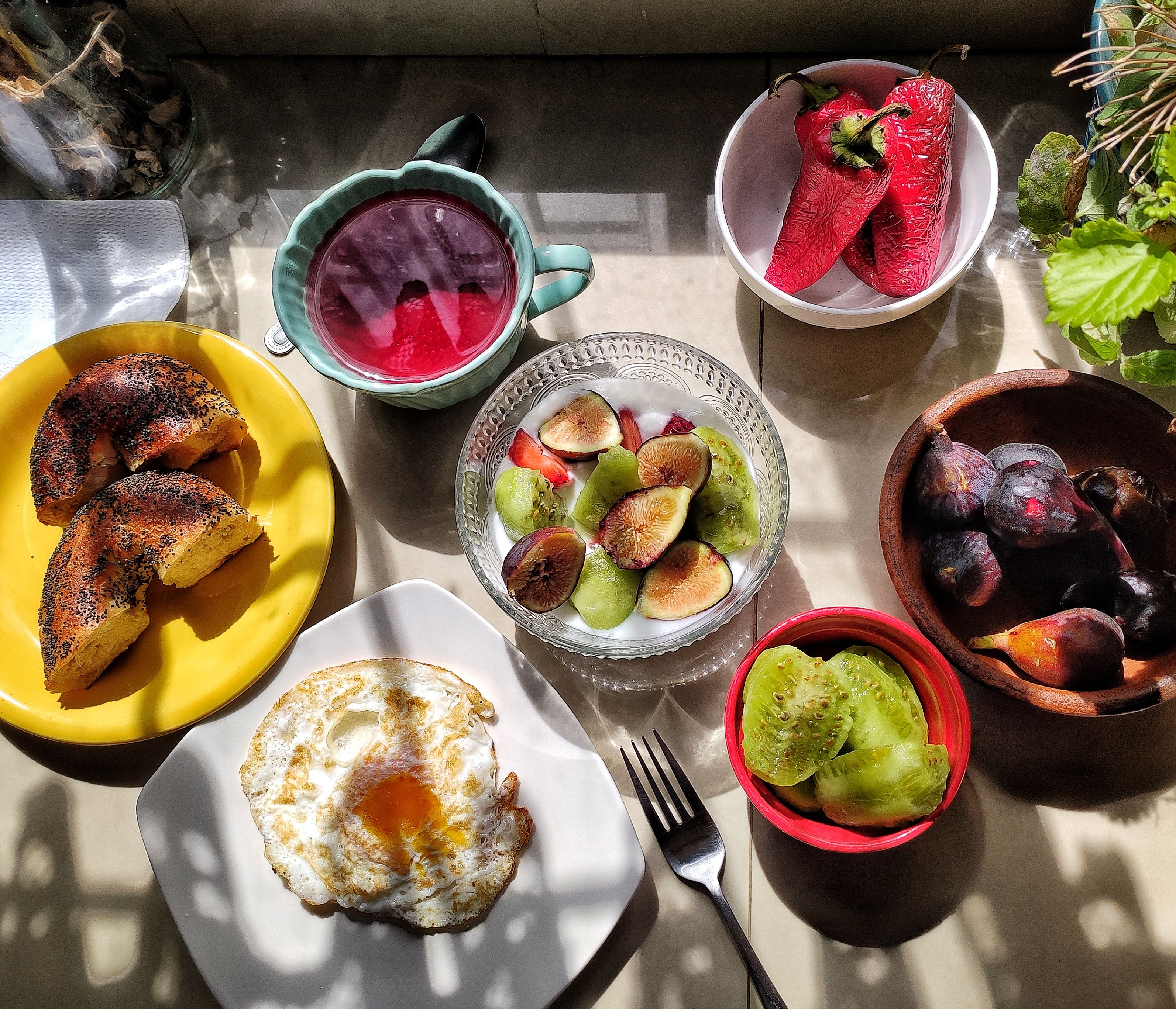 Variety of breakfast foods in sunlight.