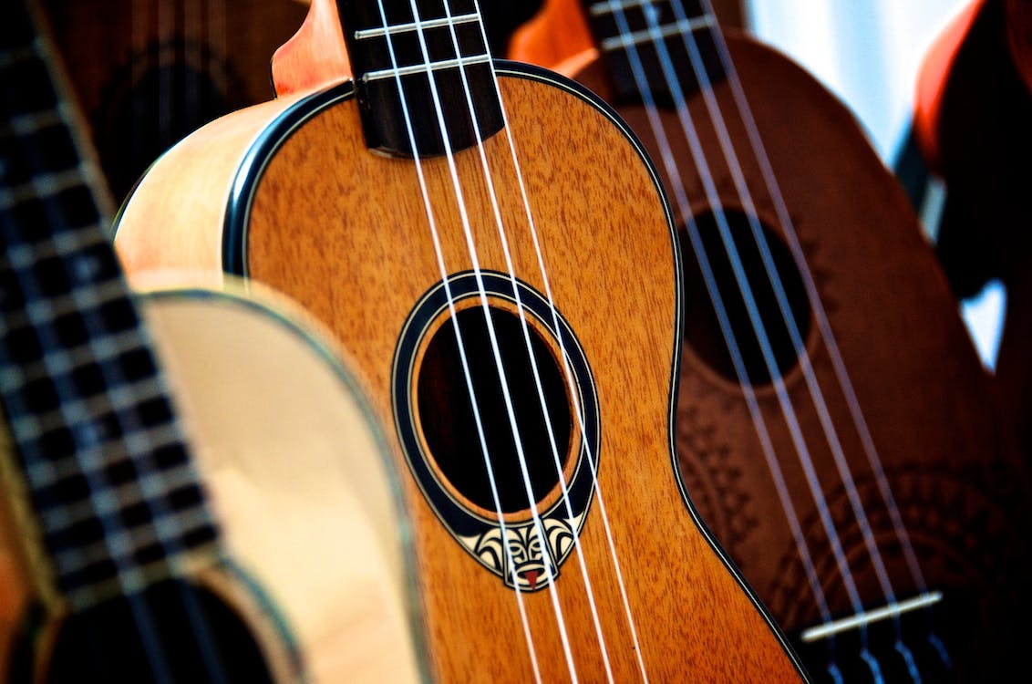 Ukulele is in the foreground, surrounded by other instruments.
