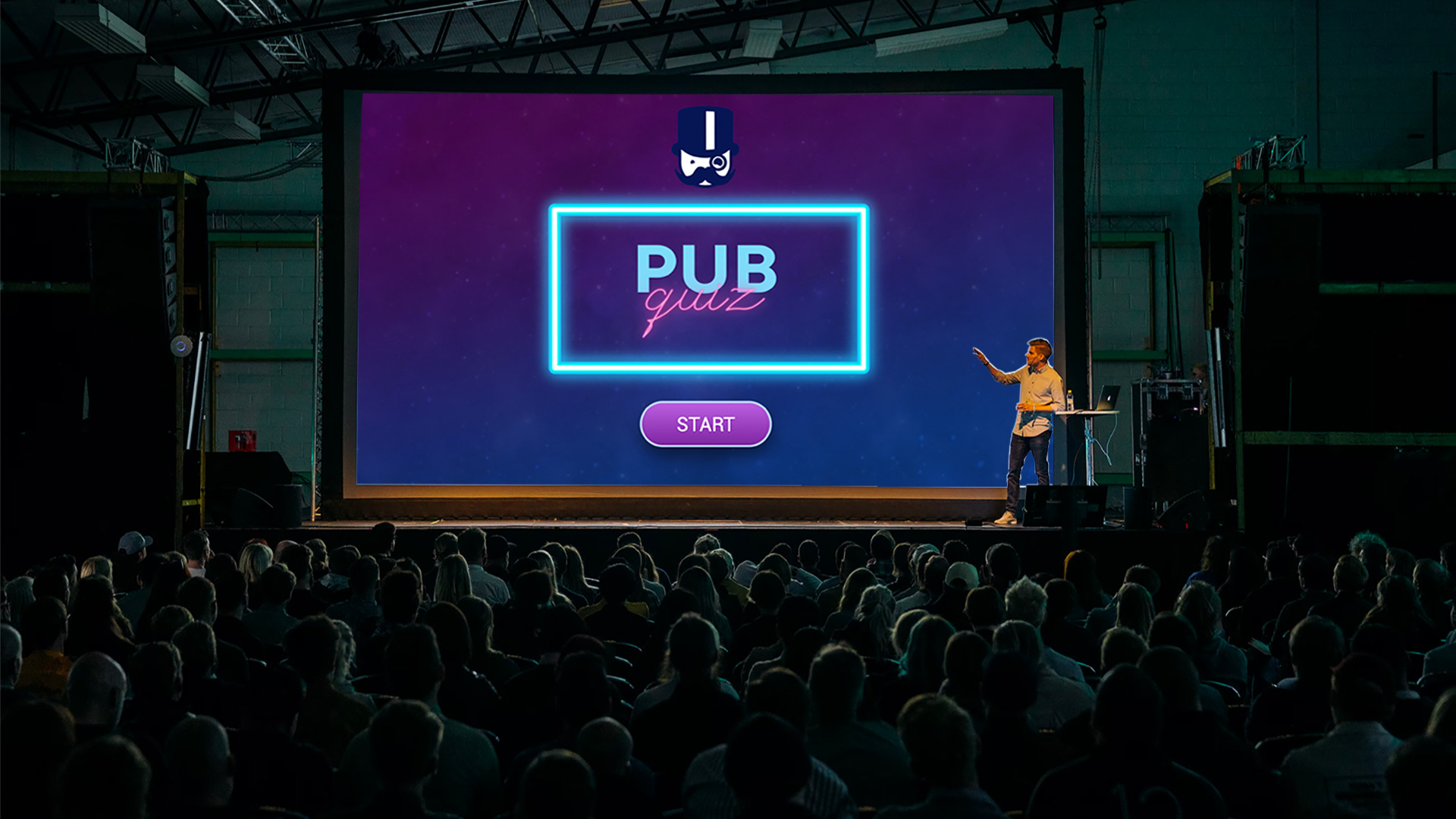 Large screen shows 'PUB quiz', presenter explains the game.