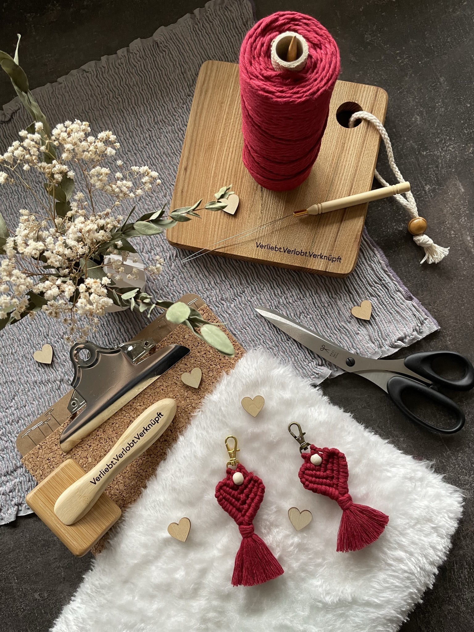 Red keychains lie on a soft surface.