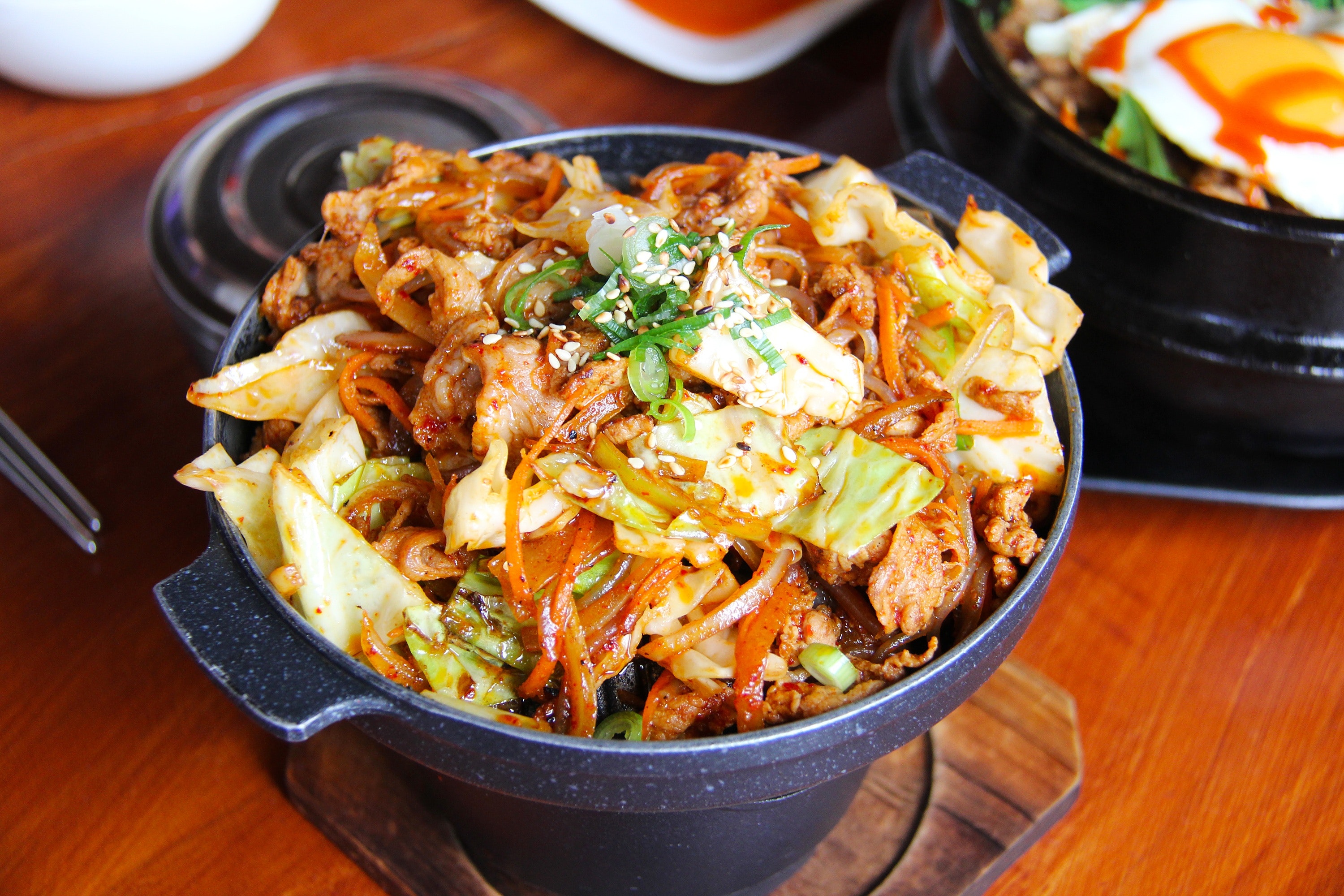 Bentone mix in black pot, cooked with vegetables and meat.