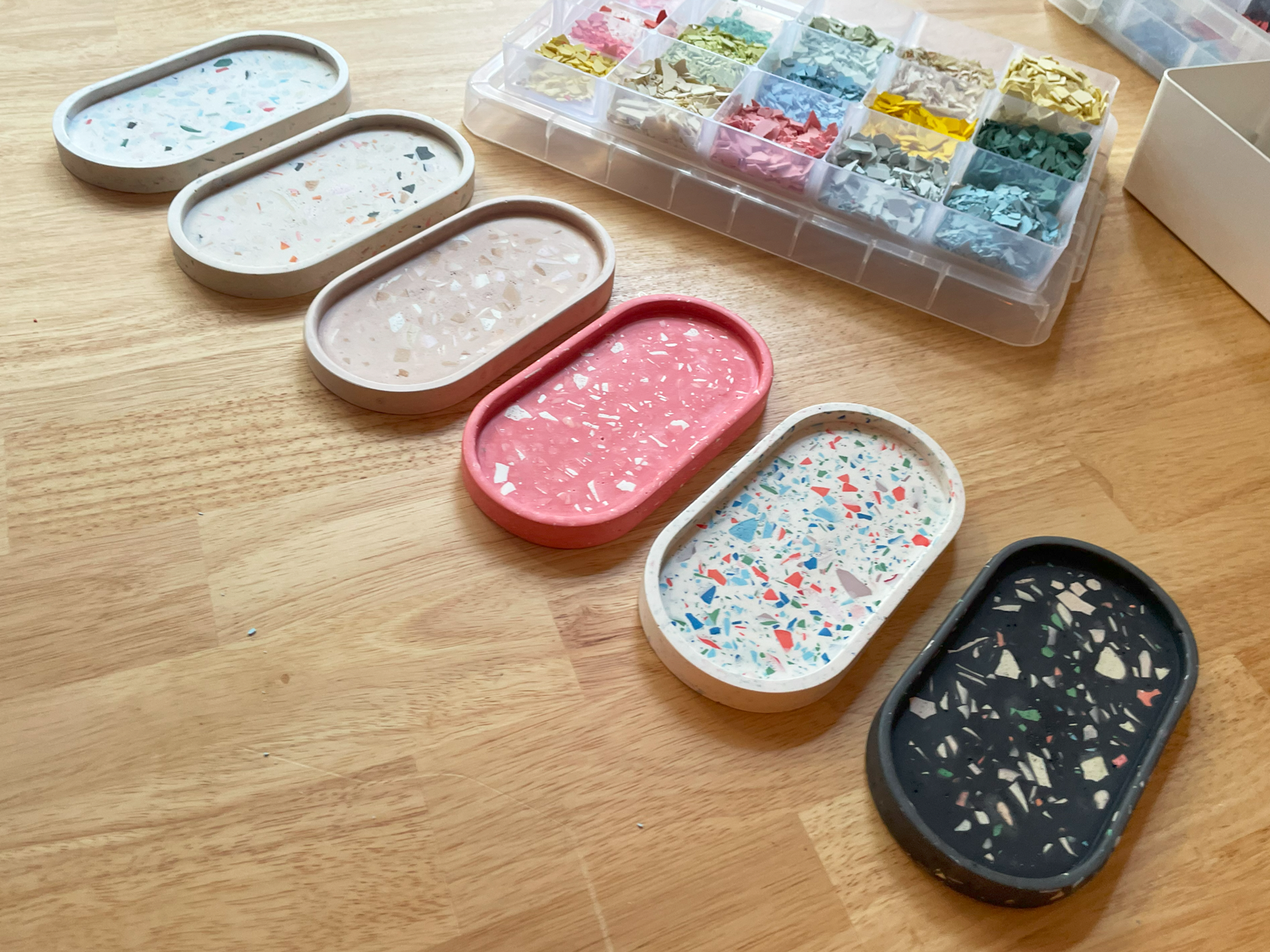 Colourful serving plates are placed on a wooden table.