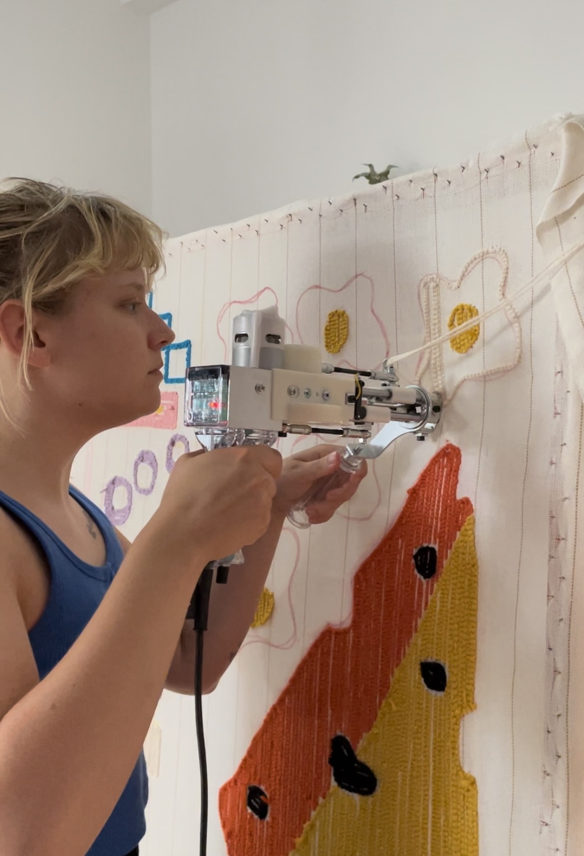 Woman uses a device to create wall decoration.