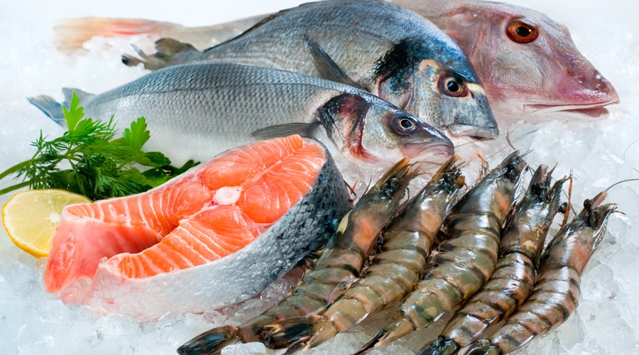 Fresh fish and shrimp are on ice.