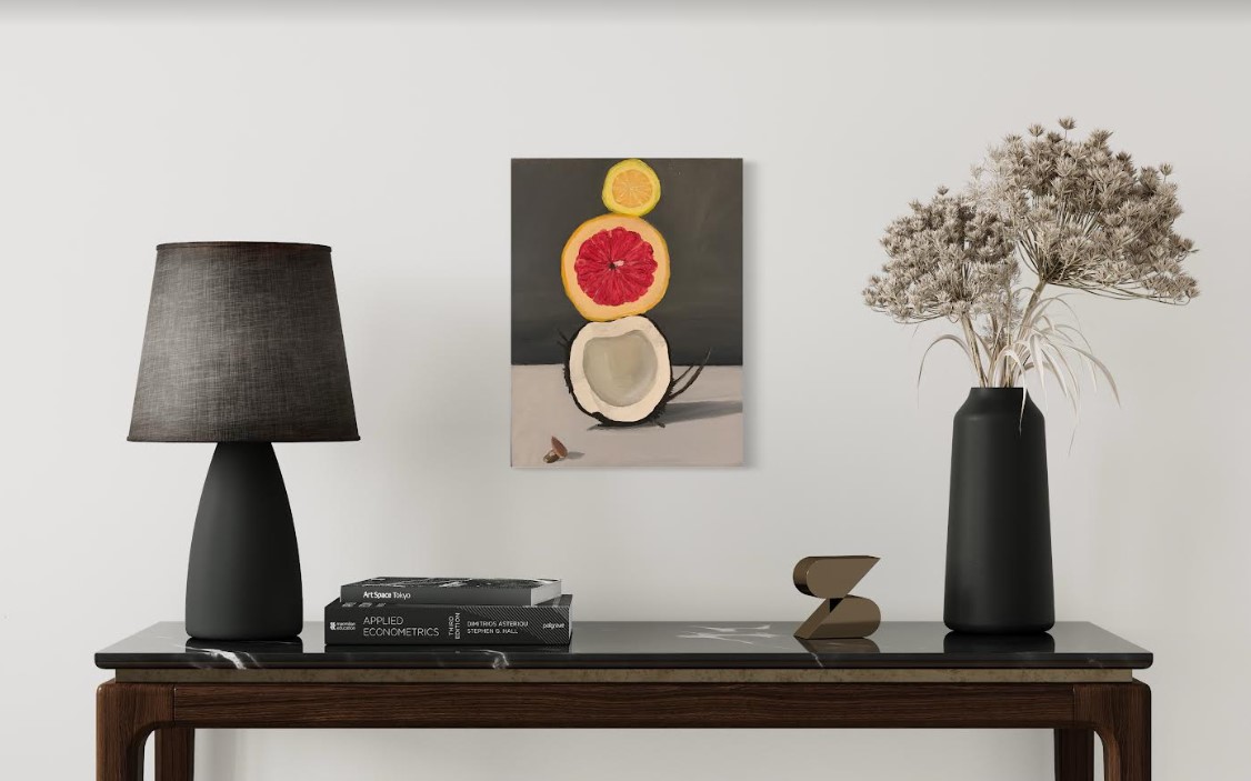 The lamp and vase are on a table with a work of art.
