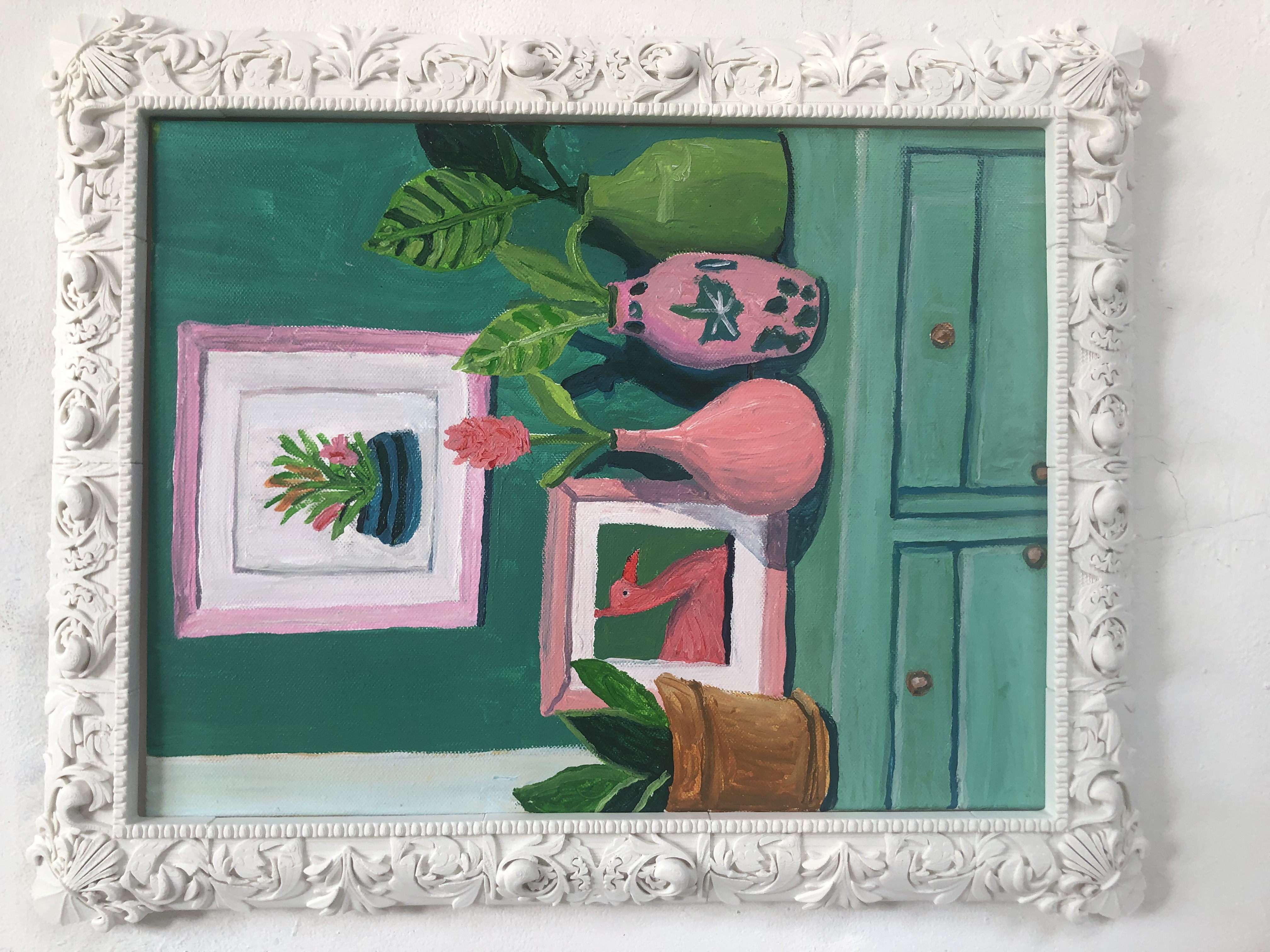 Plants and vases are placed on a framed table.