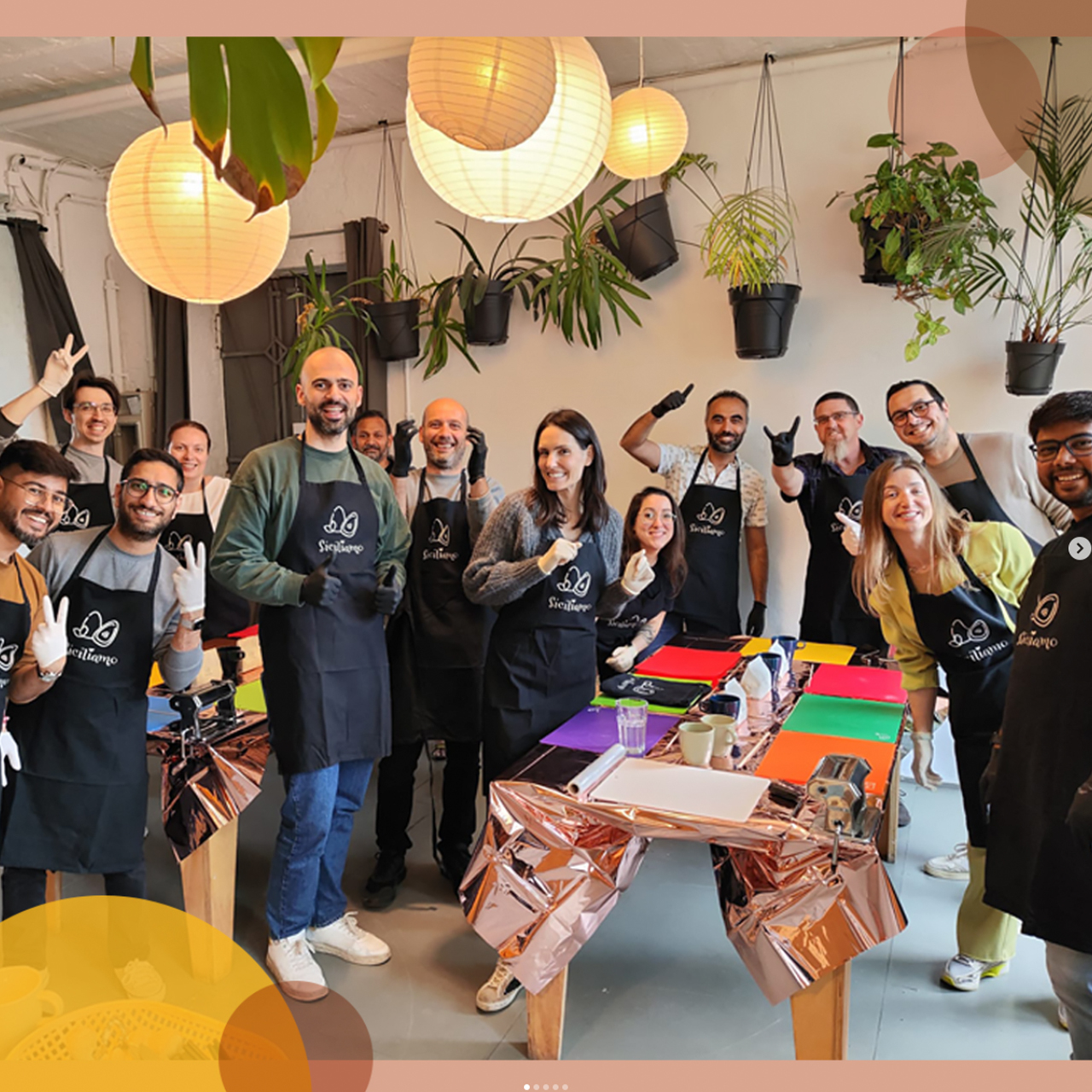 Group of people in aprons posing indoors.