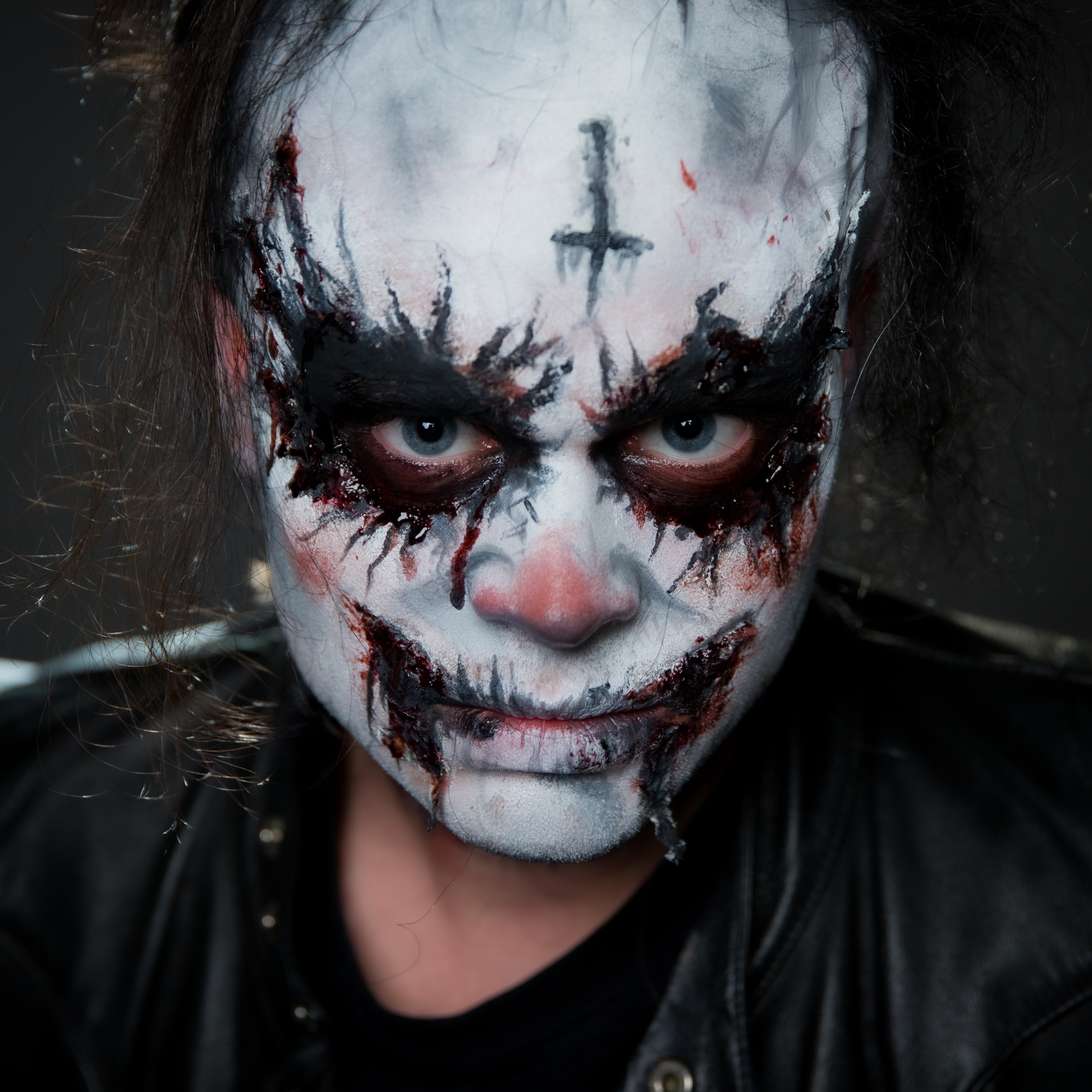 Person with creepy makeup stares intensely at the camera.