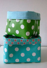 Colourful boxes are piled up, a green one with dots at the top.