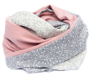 The scarf is neatly folded, with grey and pink patterns.