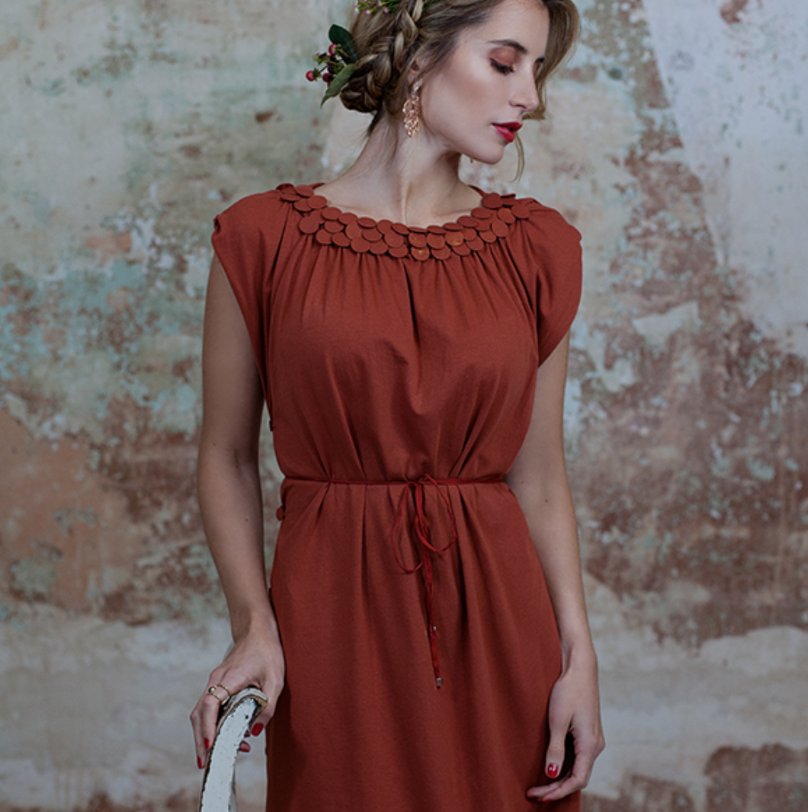 Woman in red dress with flower in hair.
