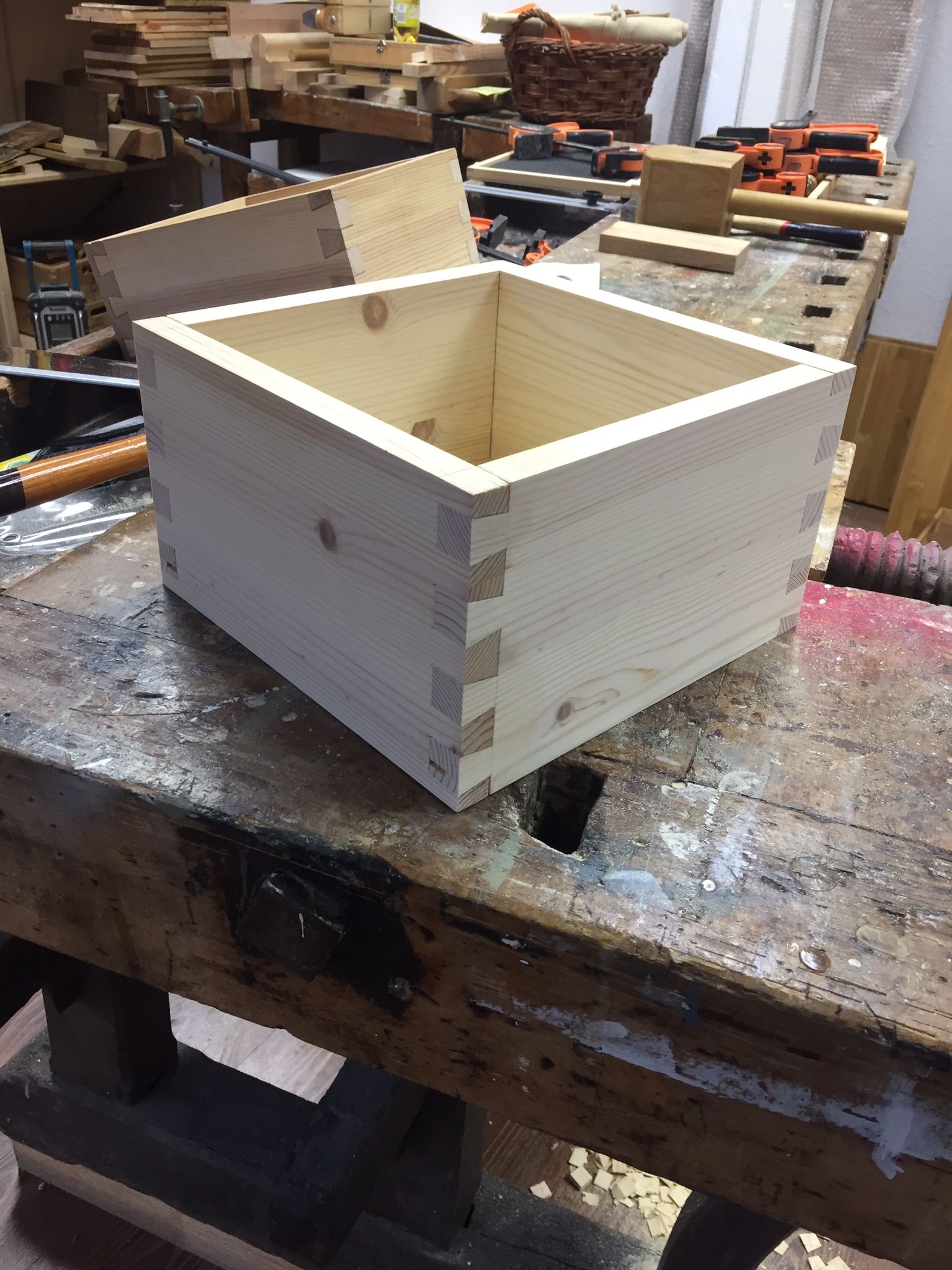 Holzkiste mit Schwalbenschwanzverbindungen, Werkstatt-Hintergrund.