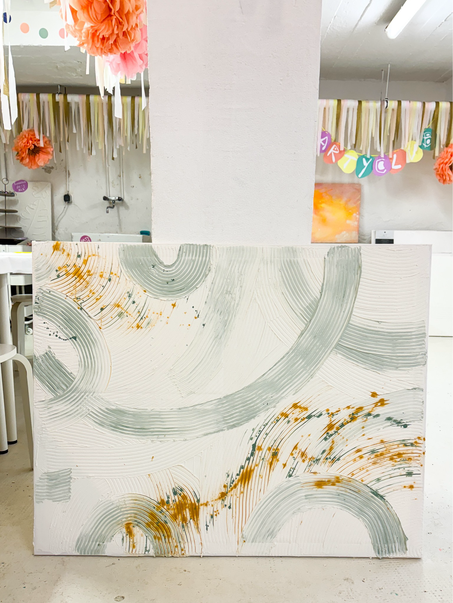 Abstract painting with circular patterns in gray and orange.