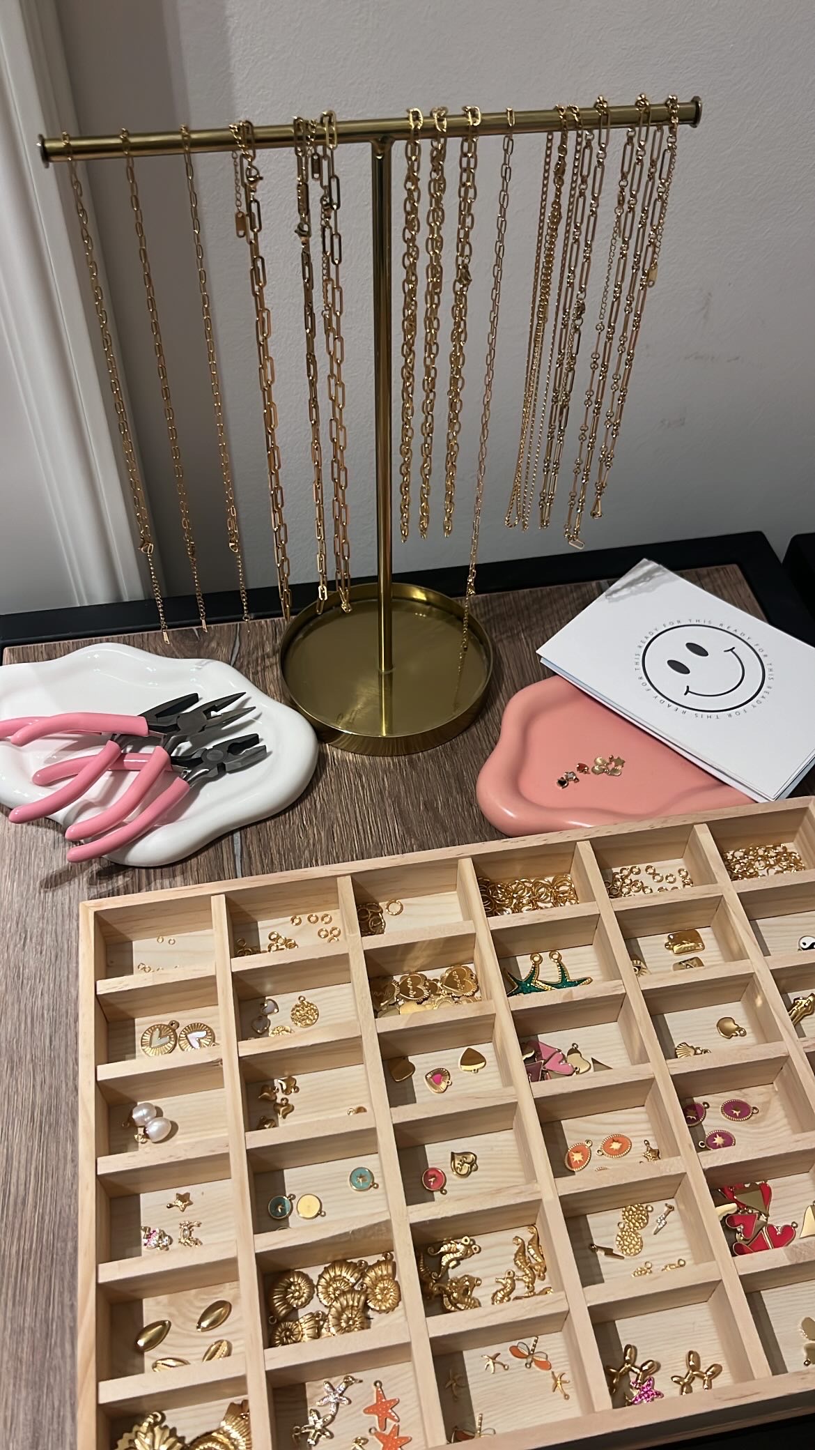 Jewelry tools and accessories on wooden table.