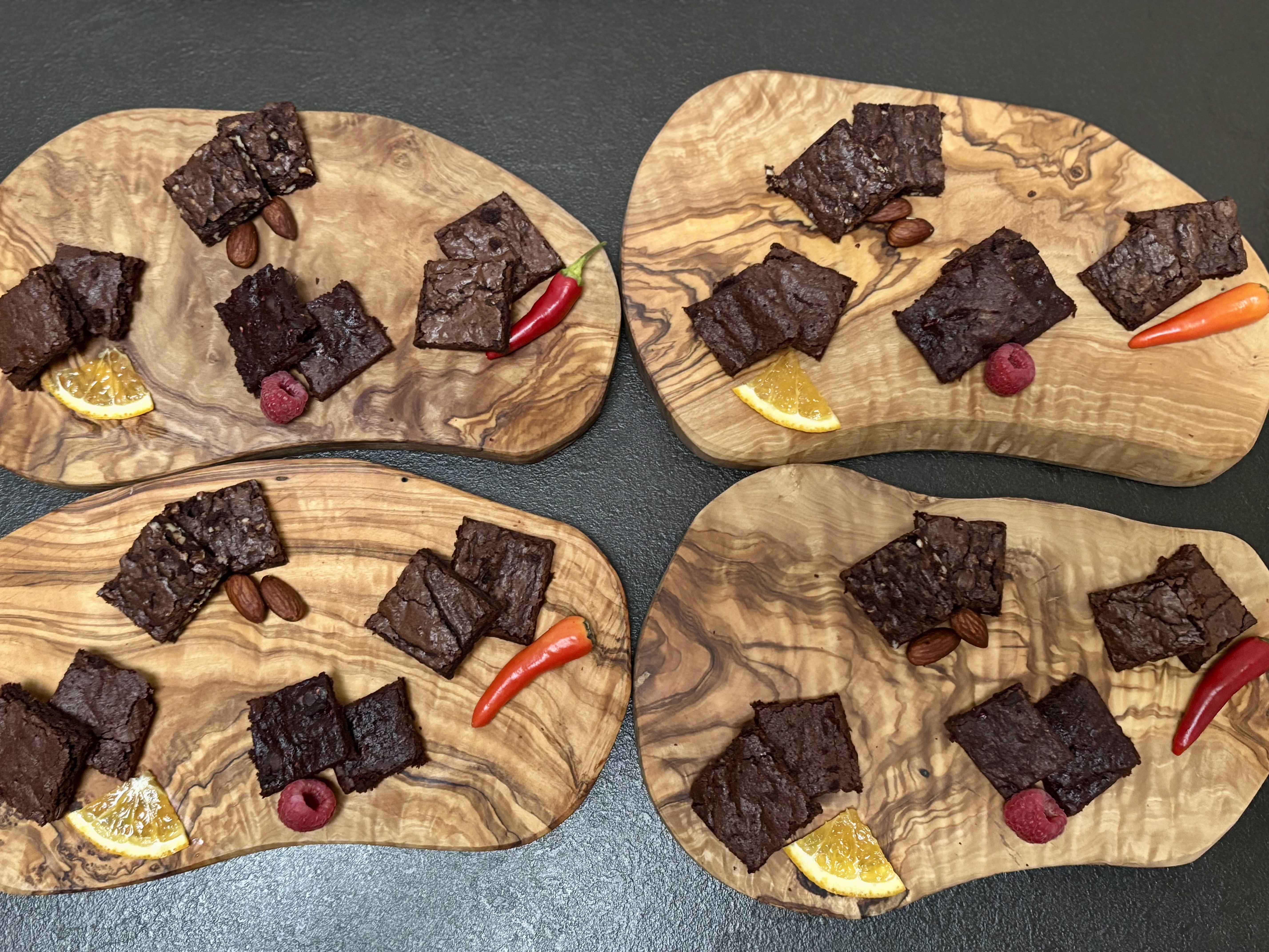 Brownies on wooden boards with garnishes.