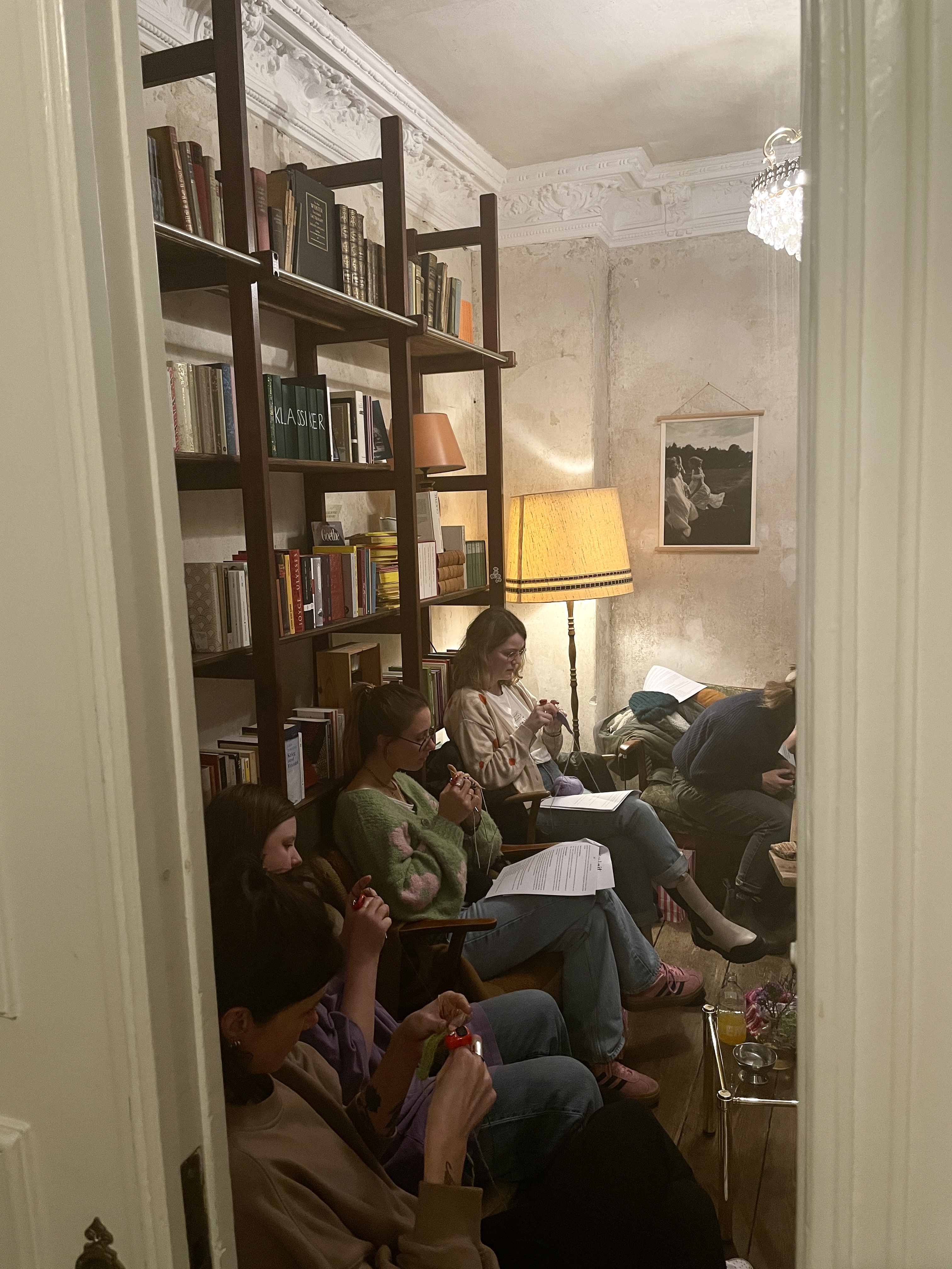 People knitting in a cozy living room.